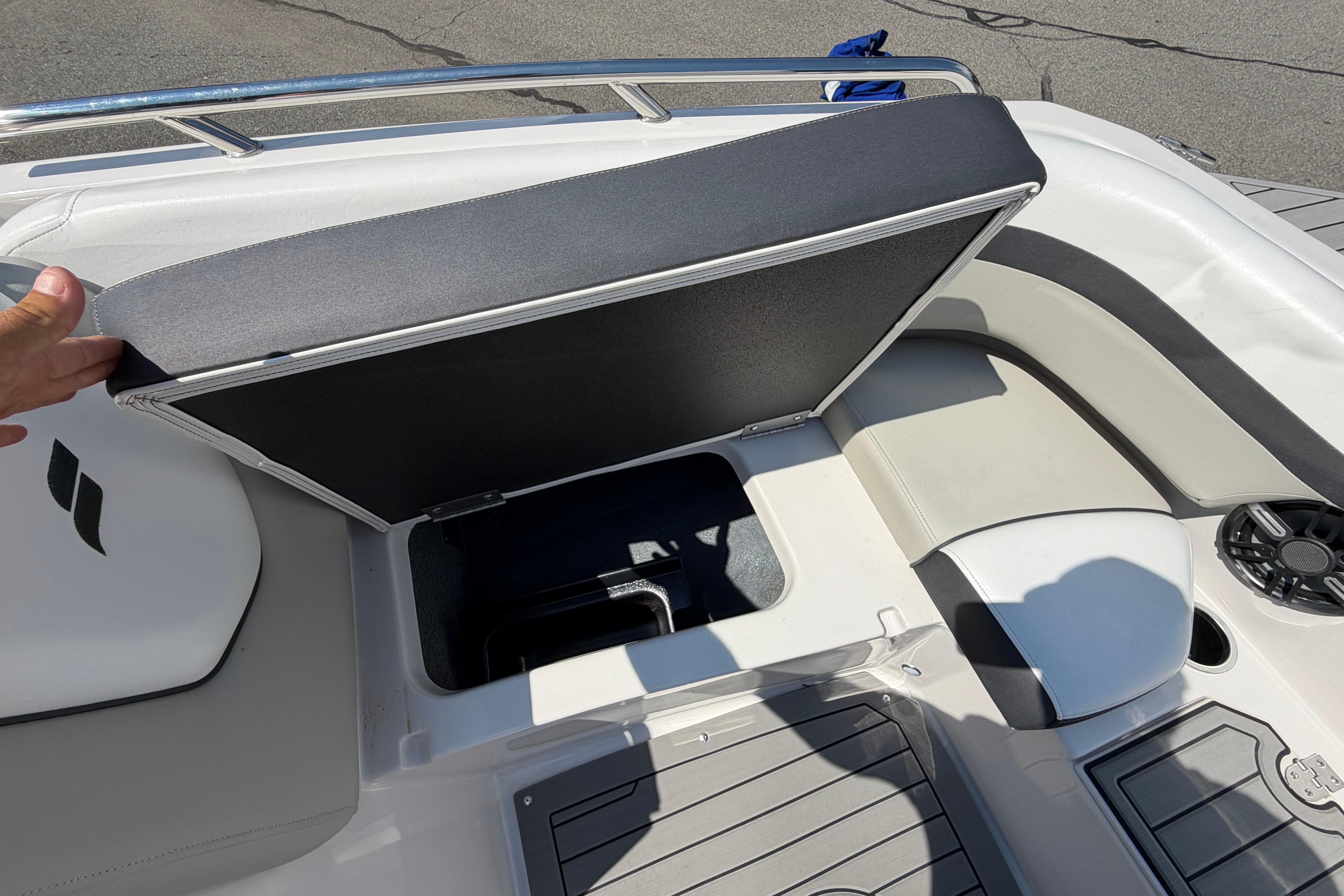 2025 Starcraft SVX 190 OB boat interior with open storage compartment and seating area.