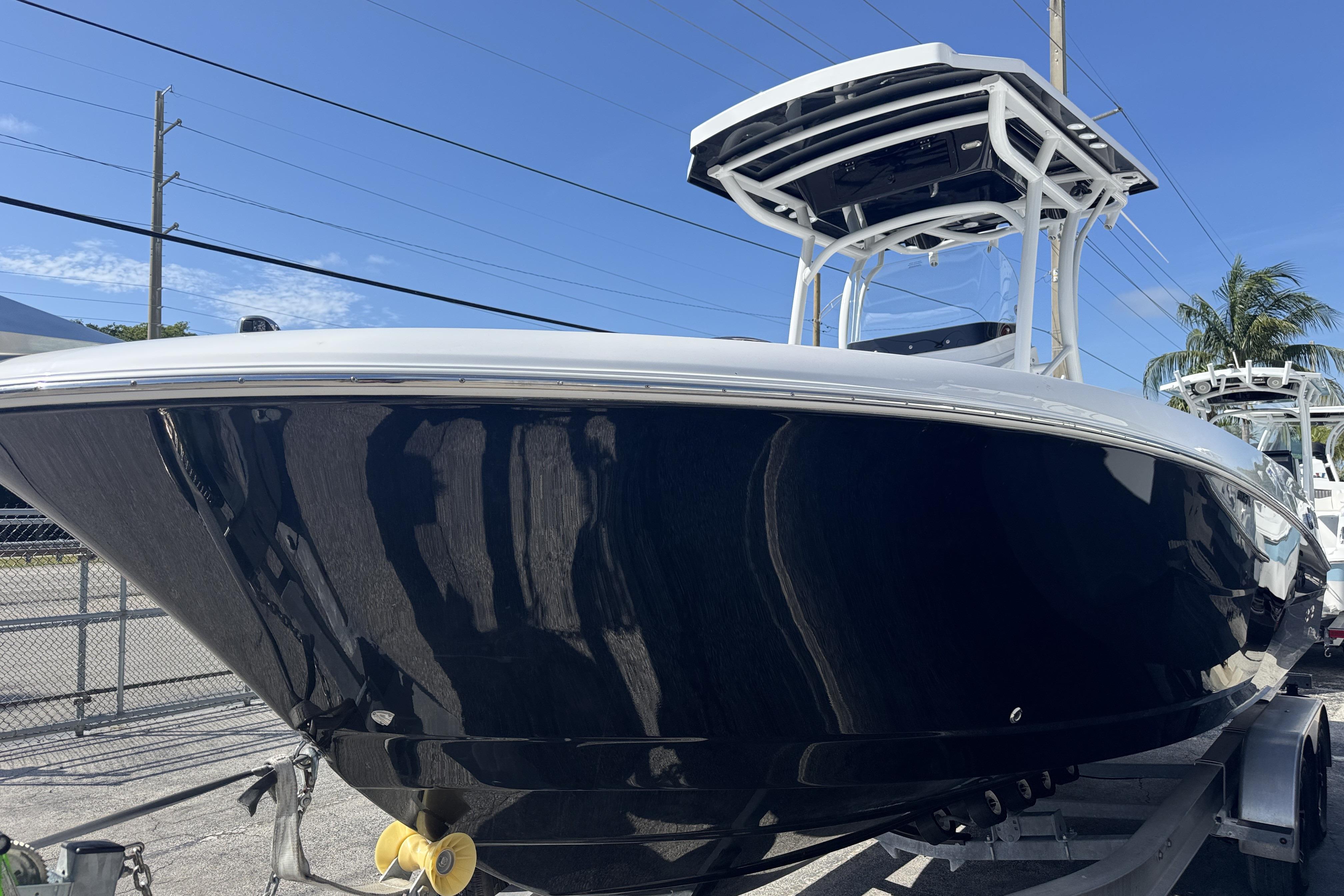 2025 Wellcraft 242 Fisherman boat with sleek black hull and modern design.