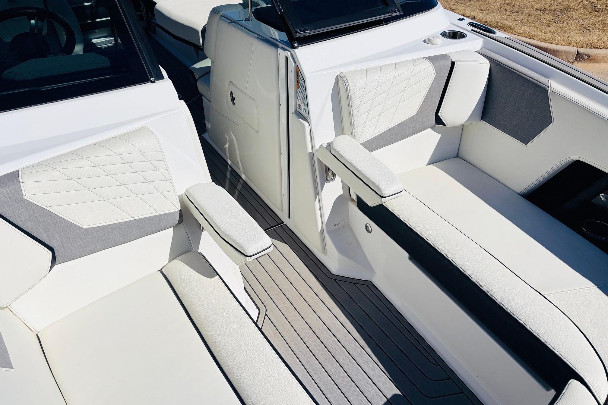 2023 Nautique Super Air Nautique G25 interior with luxurious white and gray seating.