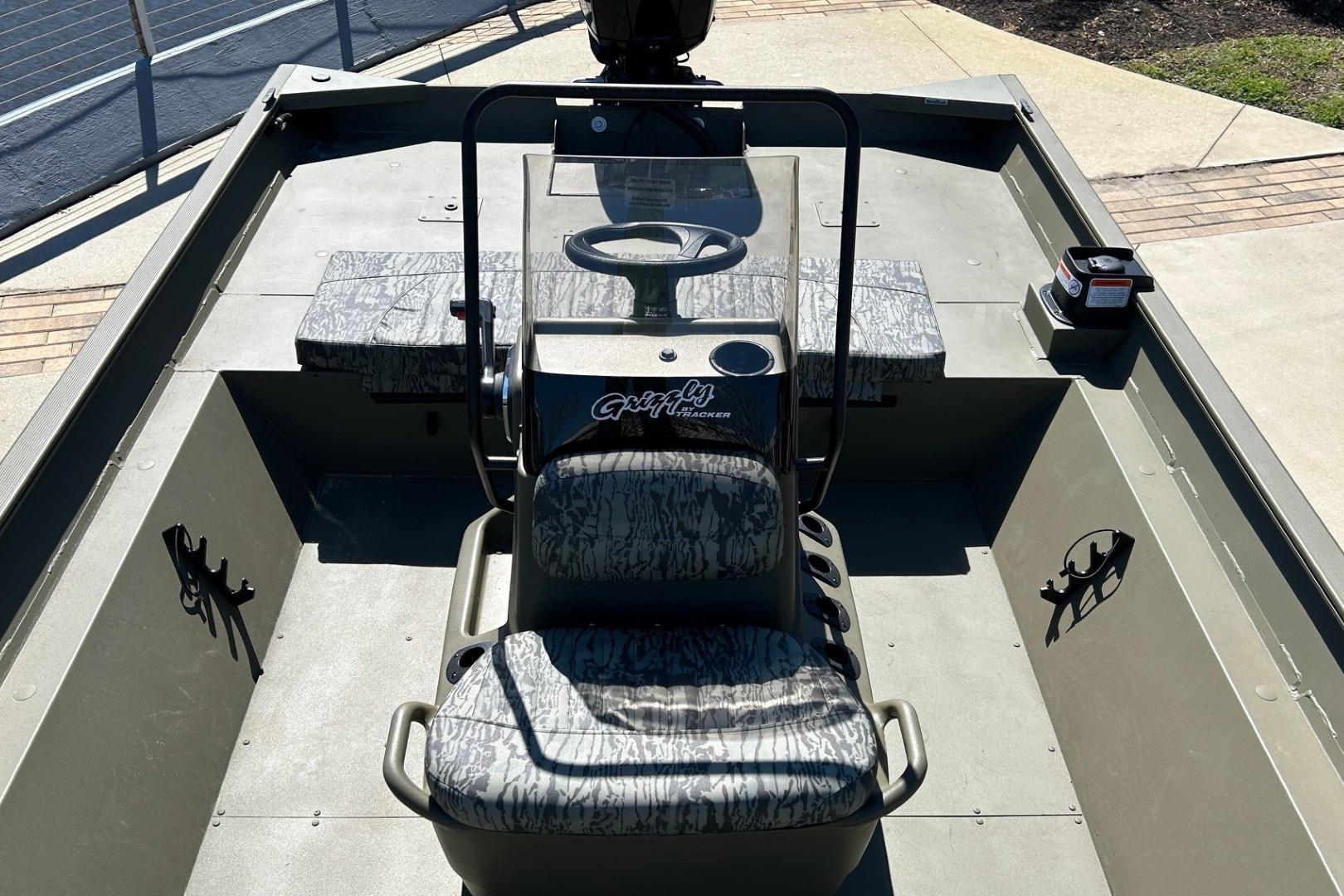 2026 Tracker Grizzly 2072 CC boat interior with camo seats and steering console.
