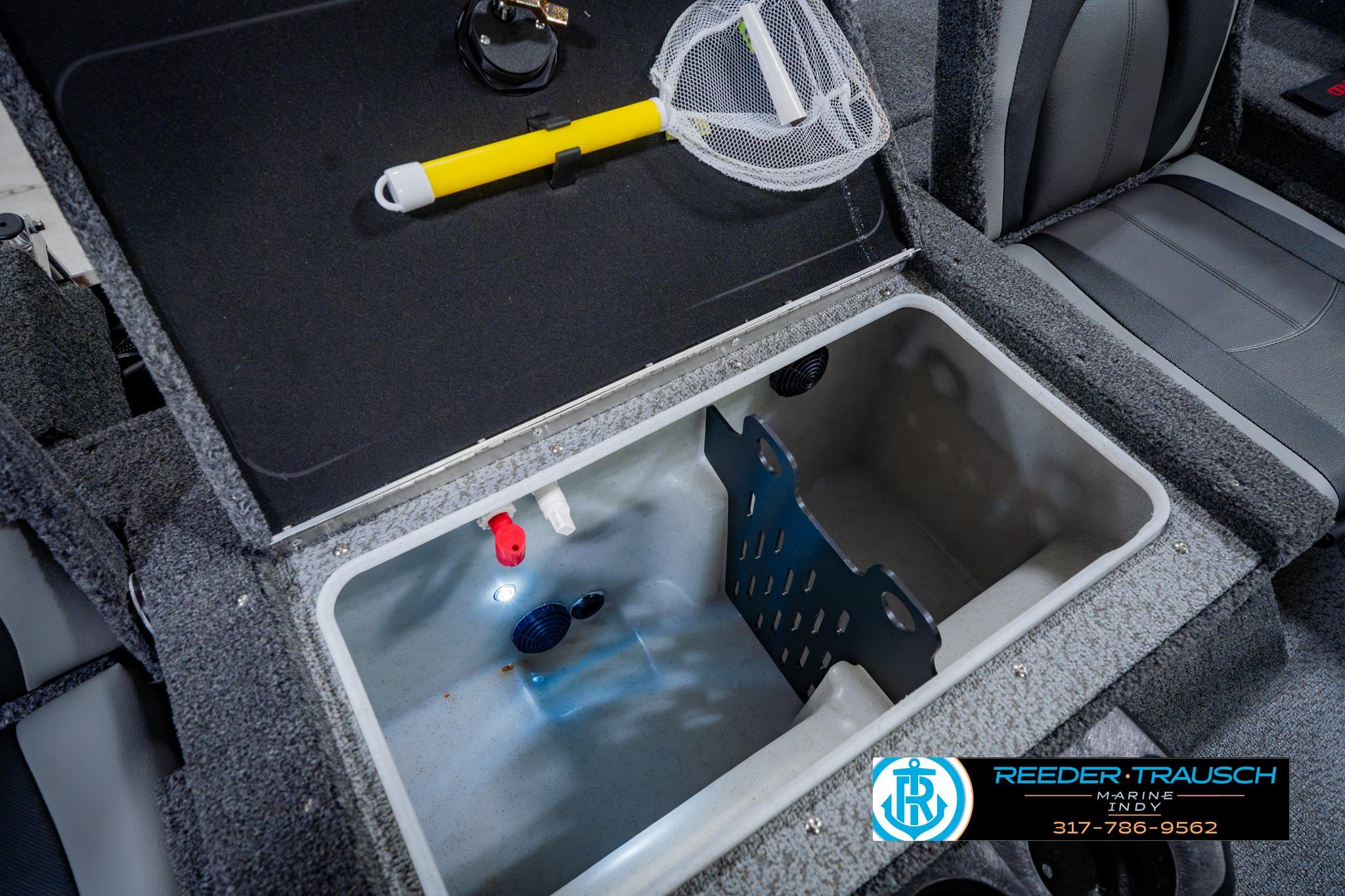 2026 Lund 1875 Impact XS boat interior storage compartment with fishing net and accessories.