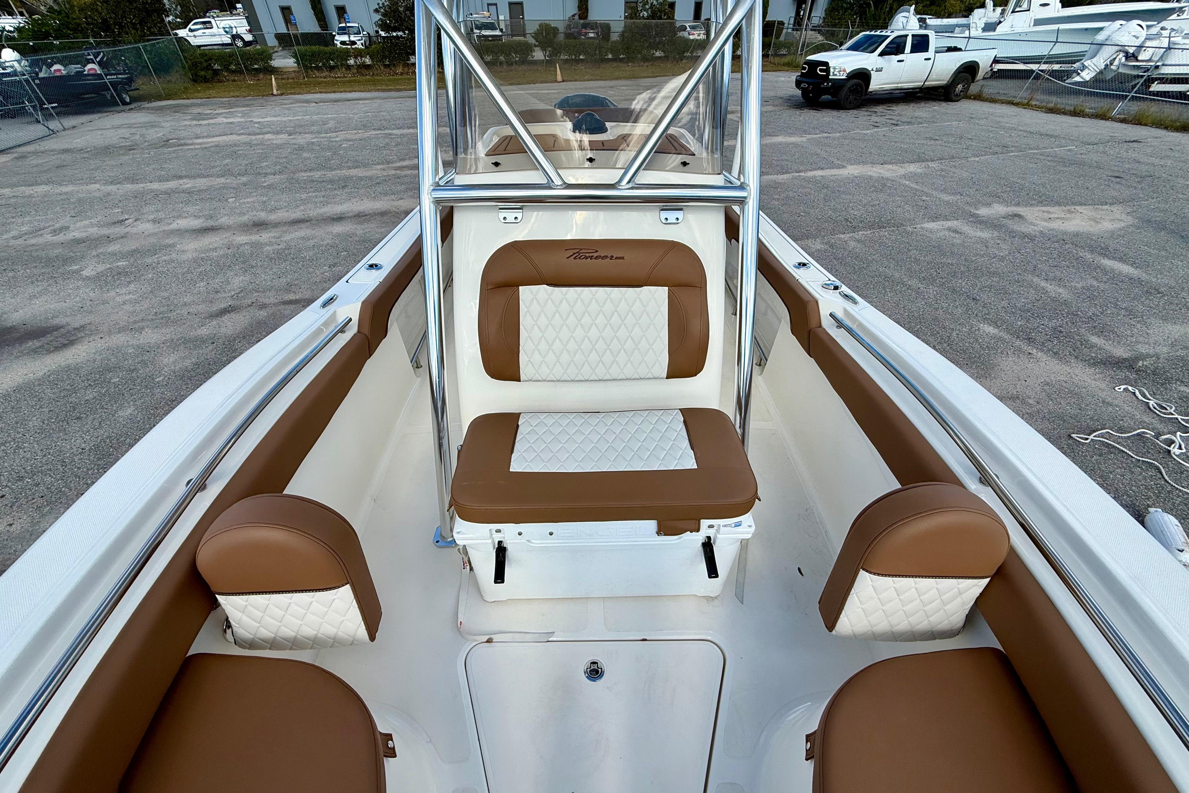 2024 Pioneer 222 Islander boat interior with brown and white seating.