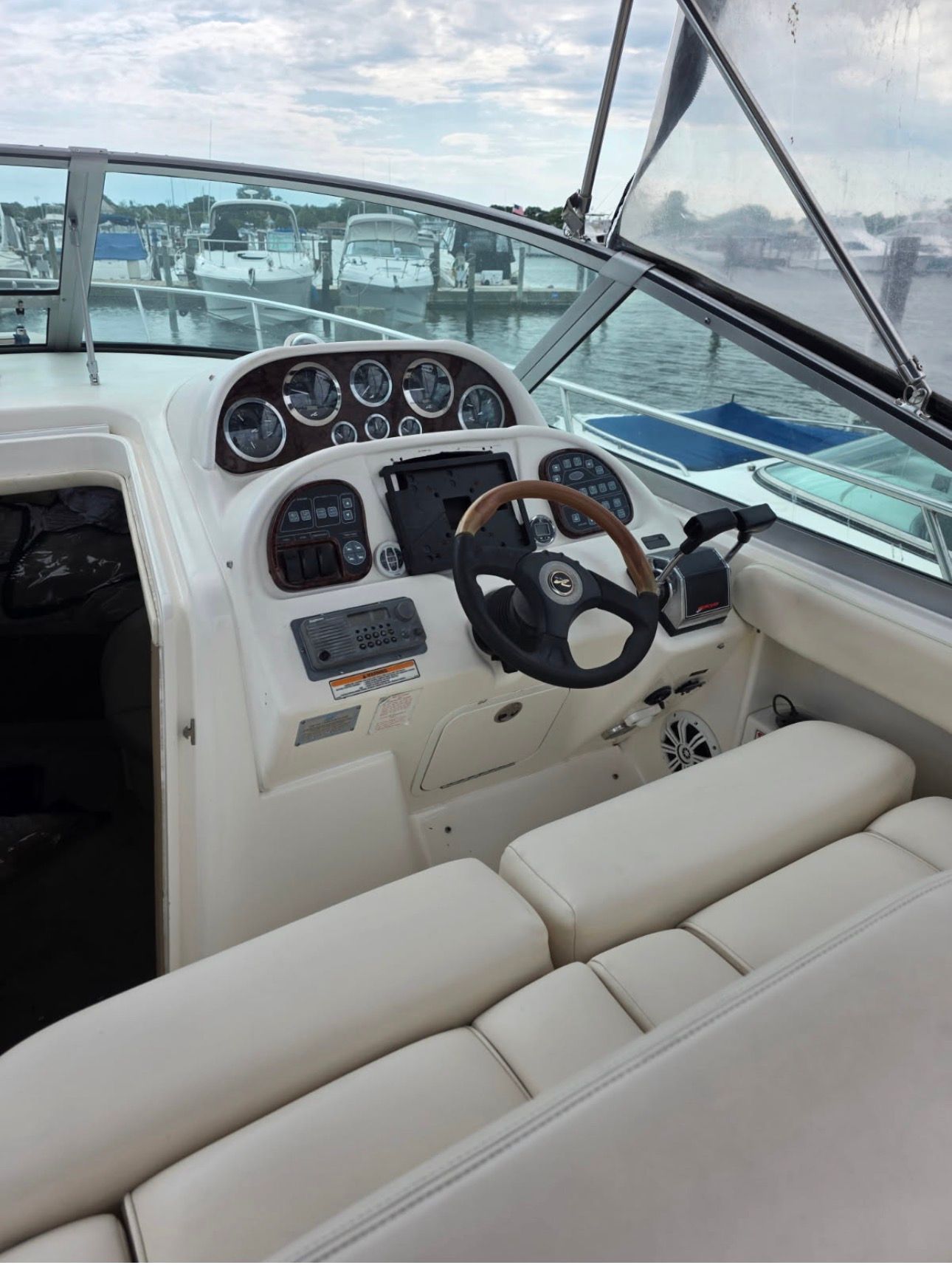 The cockpit of a 2002 Sea Ray 300 Sundancer with a sleek helm and comfortable seating.
