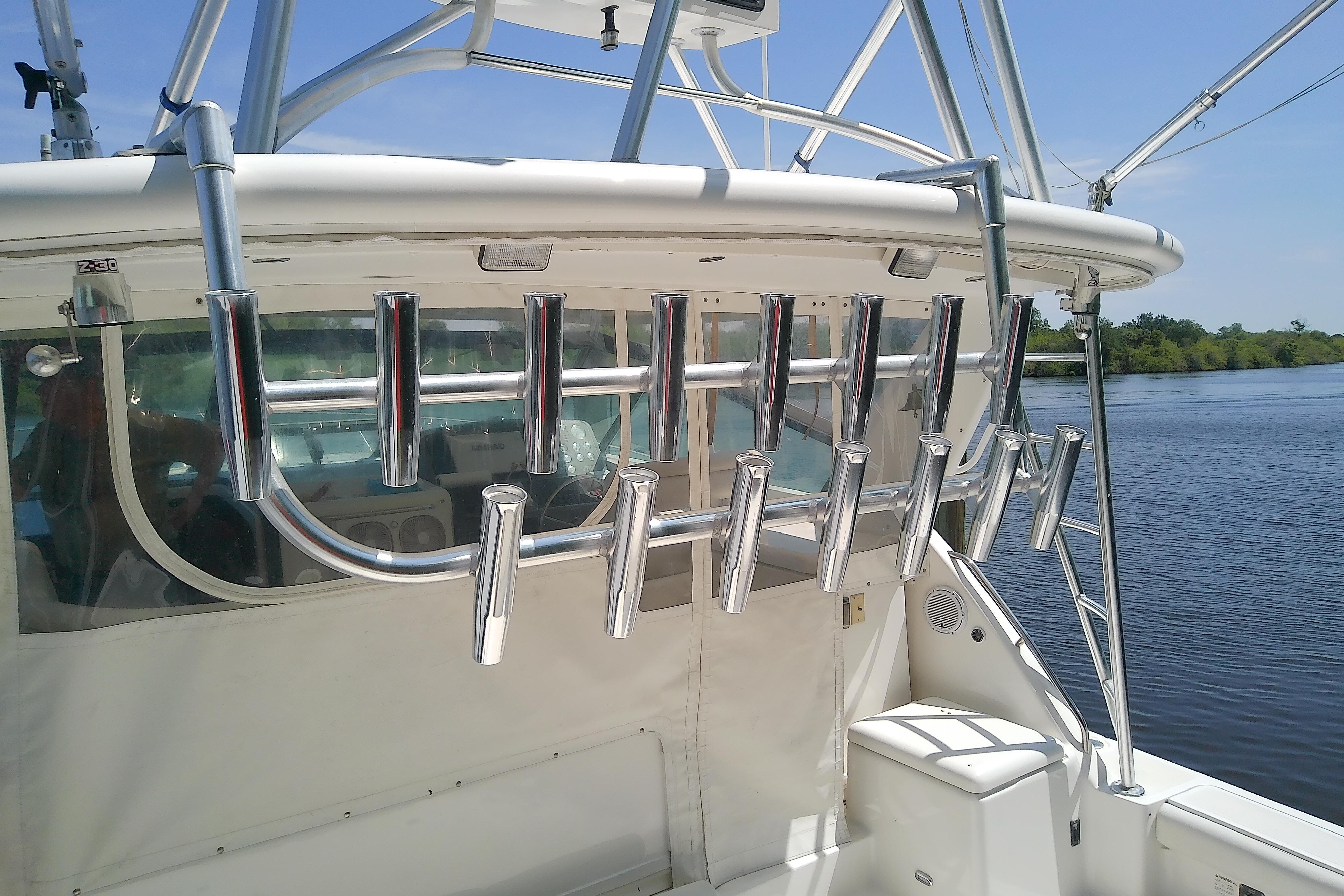 Tiara Yachts 4100 Open 2000 model with rod holders on a sunny day by the water.