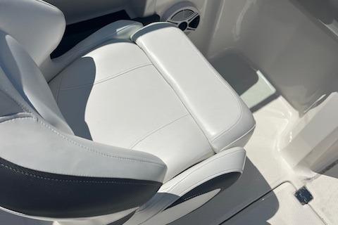 2015 Chaparral 21 H2O Sport boat seat, white leather upholstery, close-up view.