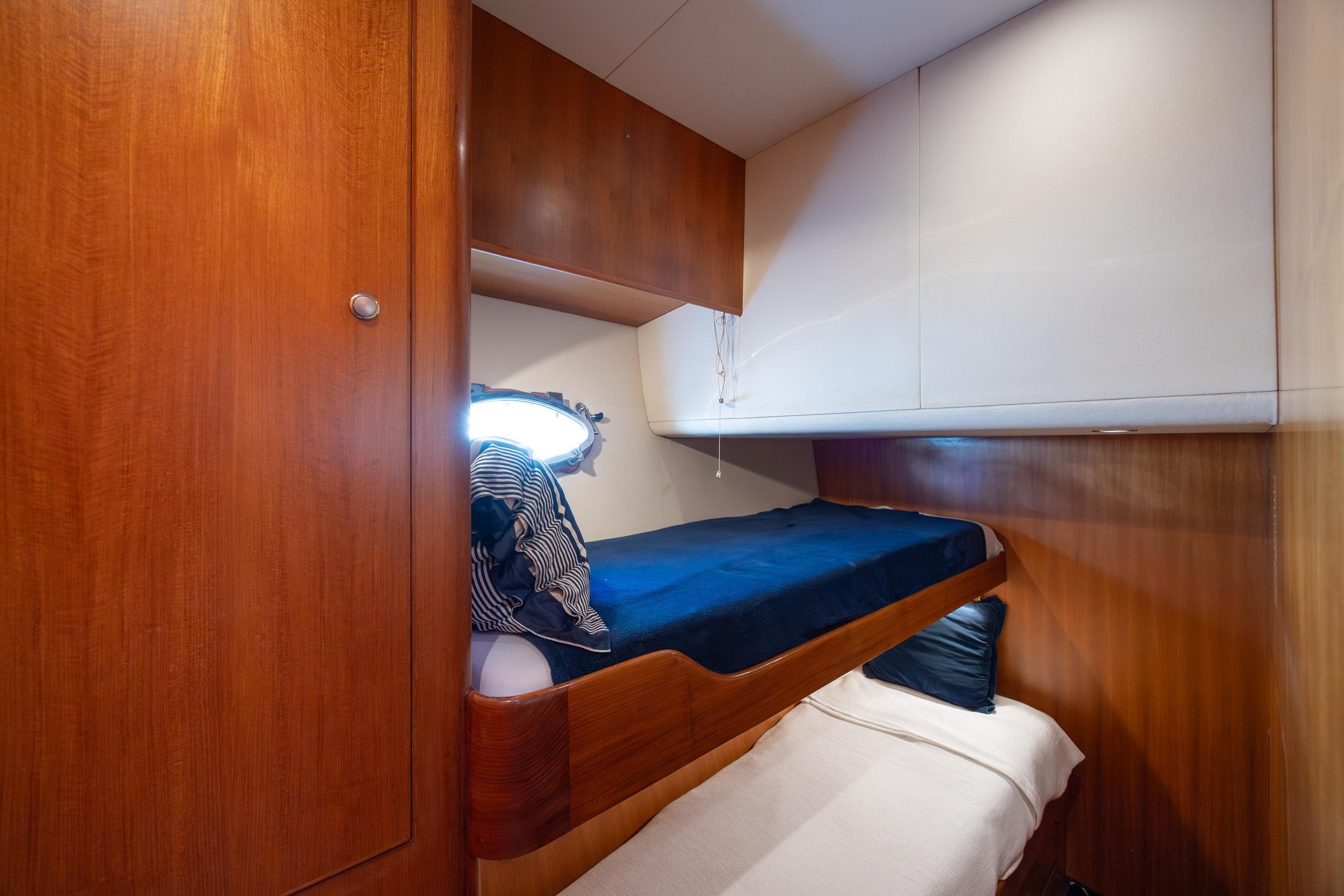 Interior cabin of 2005 Ocean Alexander 52 Sedan yacht with wooden bunk beds.