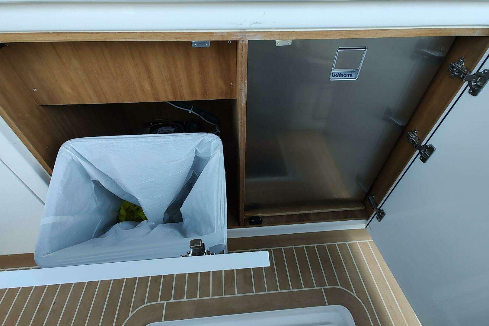 Trash bin and storage compartment on 2023 Pardo Yachts P43 boat.