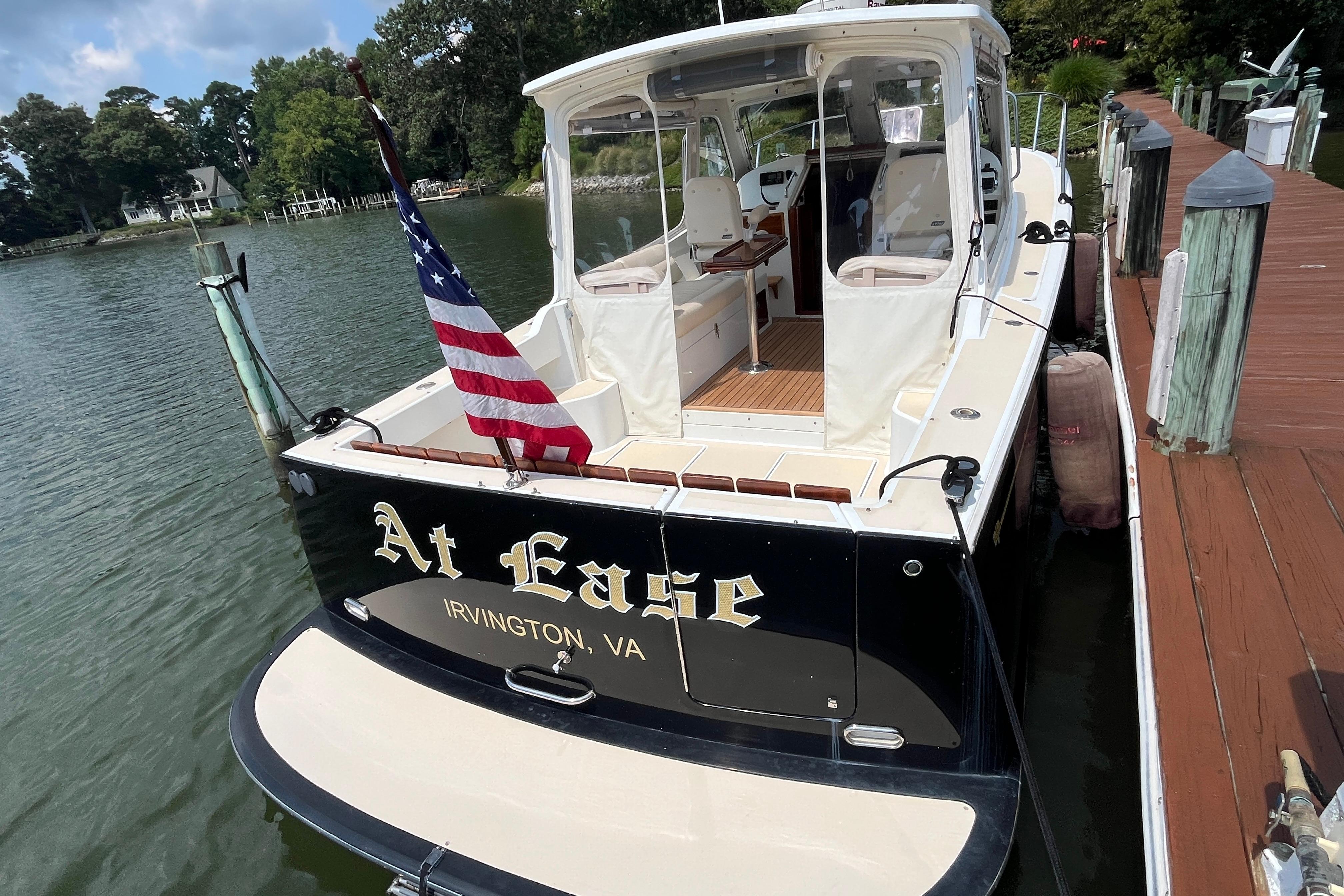 2006 MJM 34z boat docked, displaying "At Ease" and American flag, Irvington, VA.