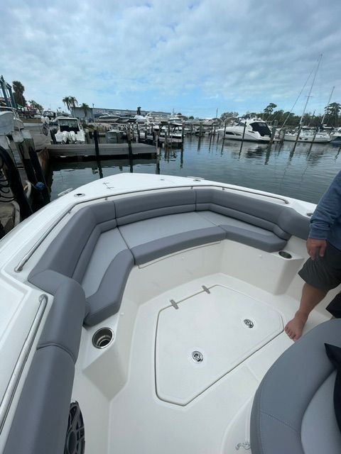 2023 Boston Whaler 330 Outrage with spacious deck at the marina.