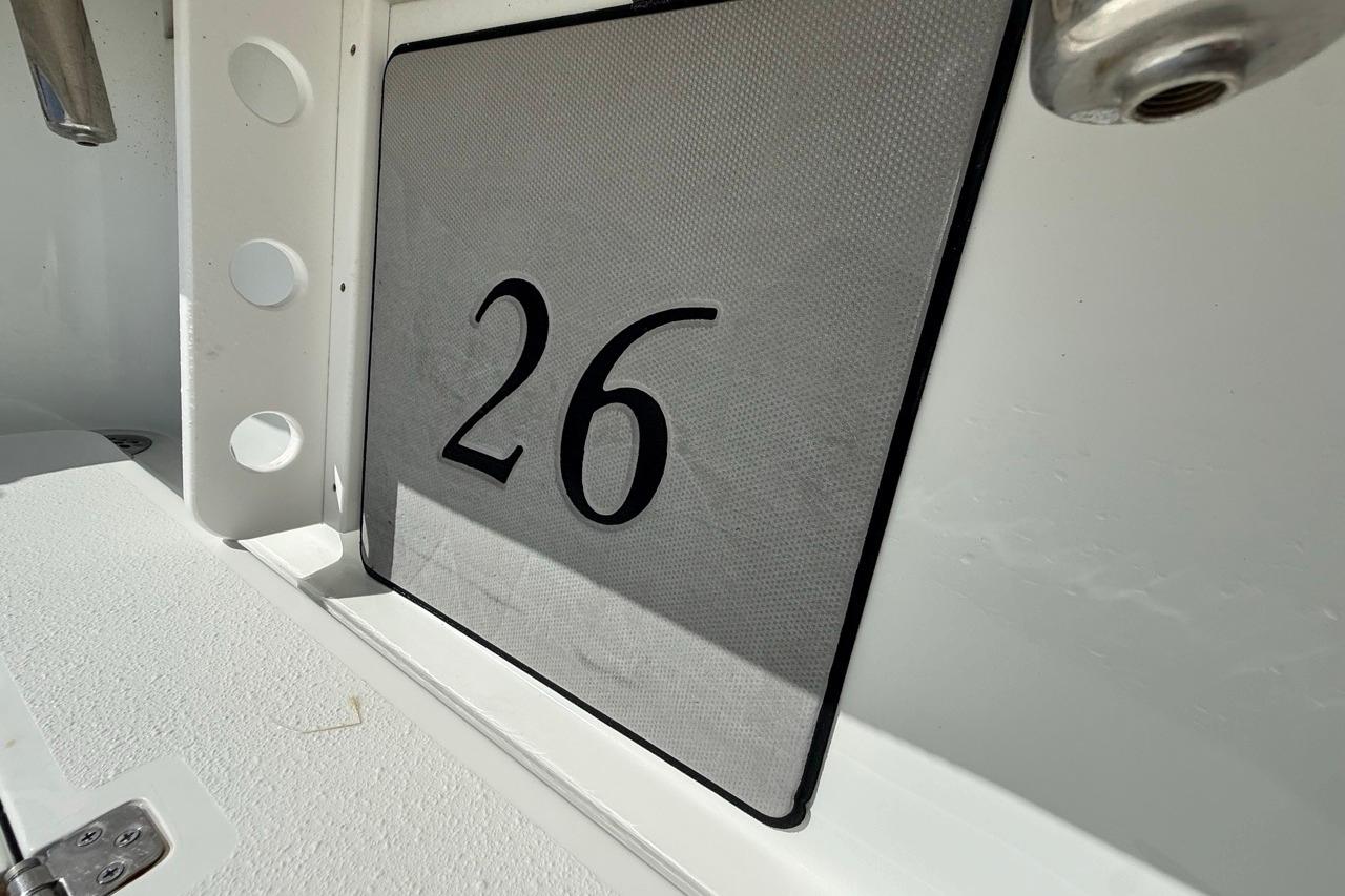 Close-up of 2017 Yellowfin 26 Hybrid boat interior with number 26 displayed.