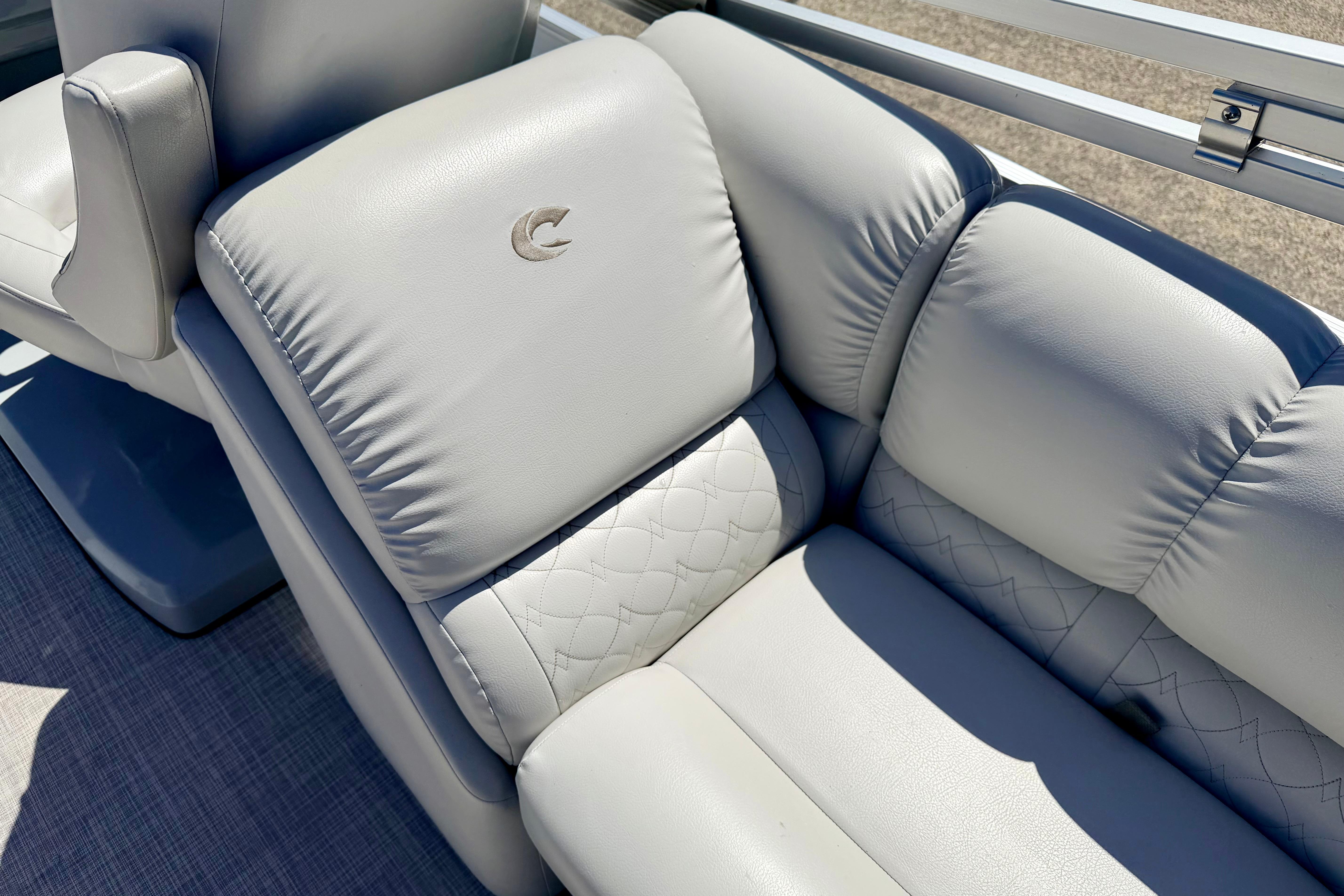 Luxurious seating on 2019 Crestliner 240 Rally DX CW boat, featuring elegant stitching and logo.