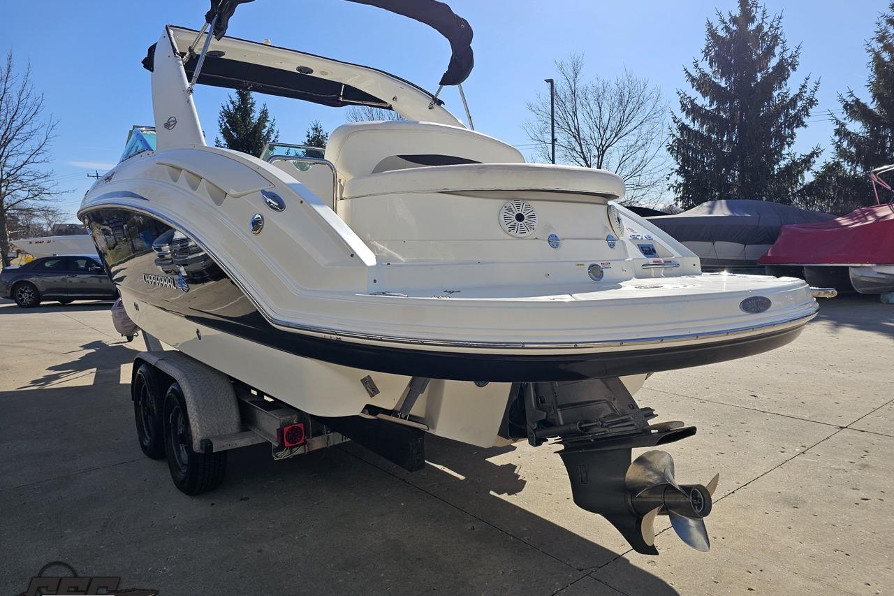 2010 Chaparral 276 SSX boat on trailer, rear view, outdoors.