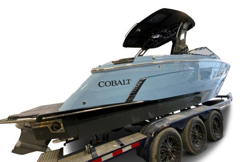 2026 Cobalt R8 Surf boat on trailer, sleek design, light blue color.