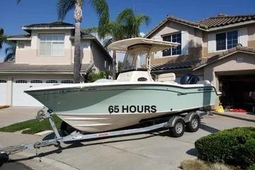 2018 Grady-White Fisherman 216 boat on trailer in suburban driveway.