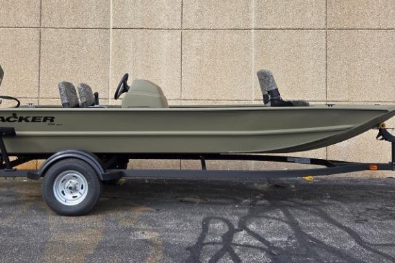 2026 Tracker Grizzly 1754 SC boat on trailer, side view against concrete wall.