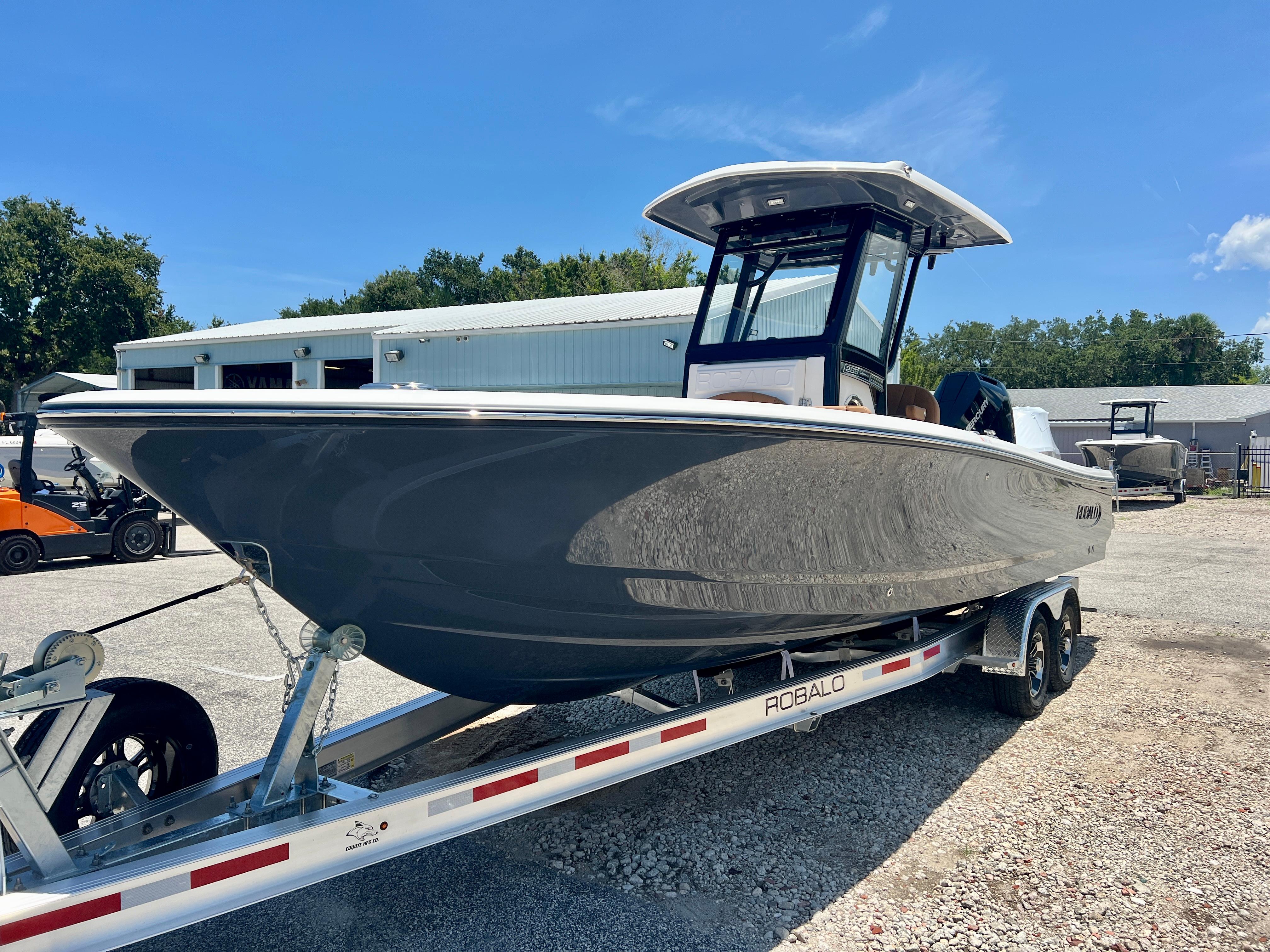 2025 Robalo 266 Cayman boat on trailer outdoors.