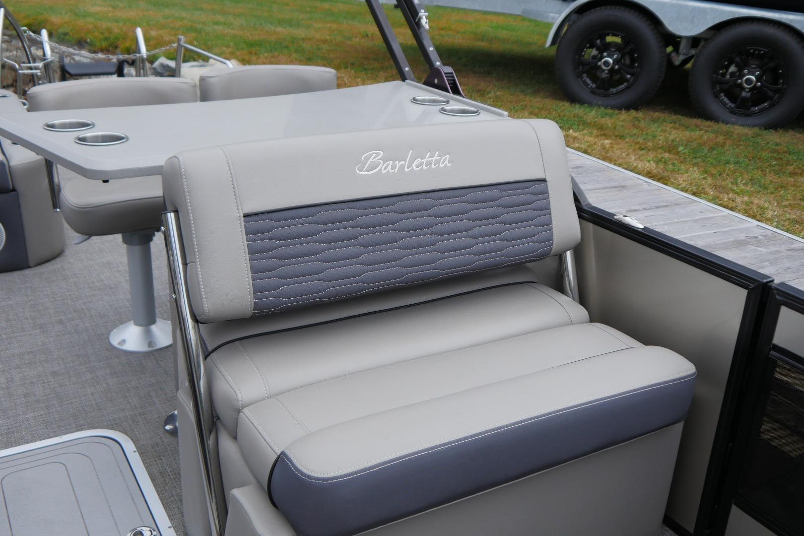 2023 Barletta CORSA 25UE boat interior with gray seating and cup holders.