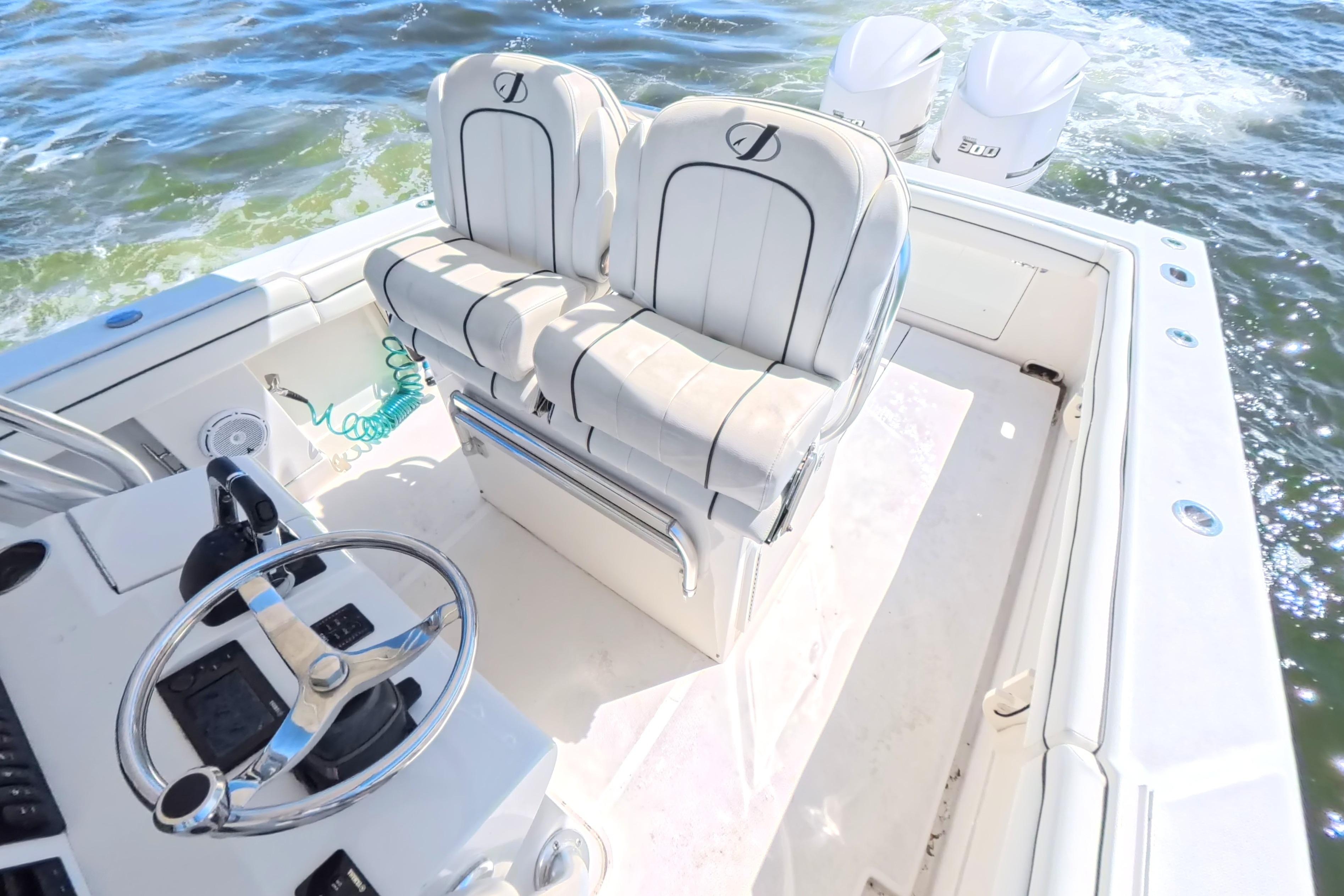 2014 Jupiter 30 FS boat interior with dual seats and steering wheel on open water.