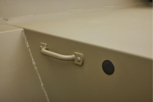 2025 Tracker GRIZZLY 2072 Utility boat interior with handle and circular feature.