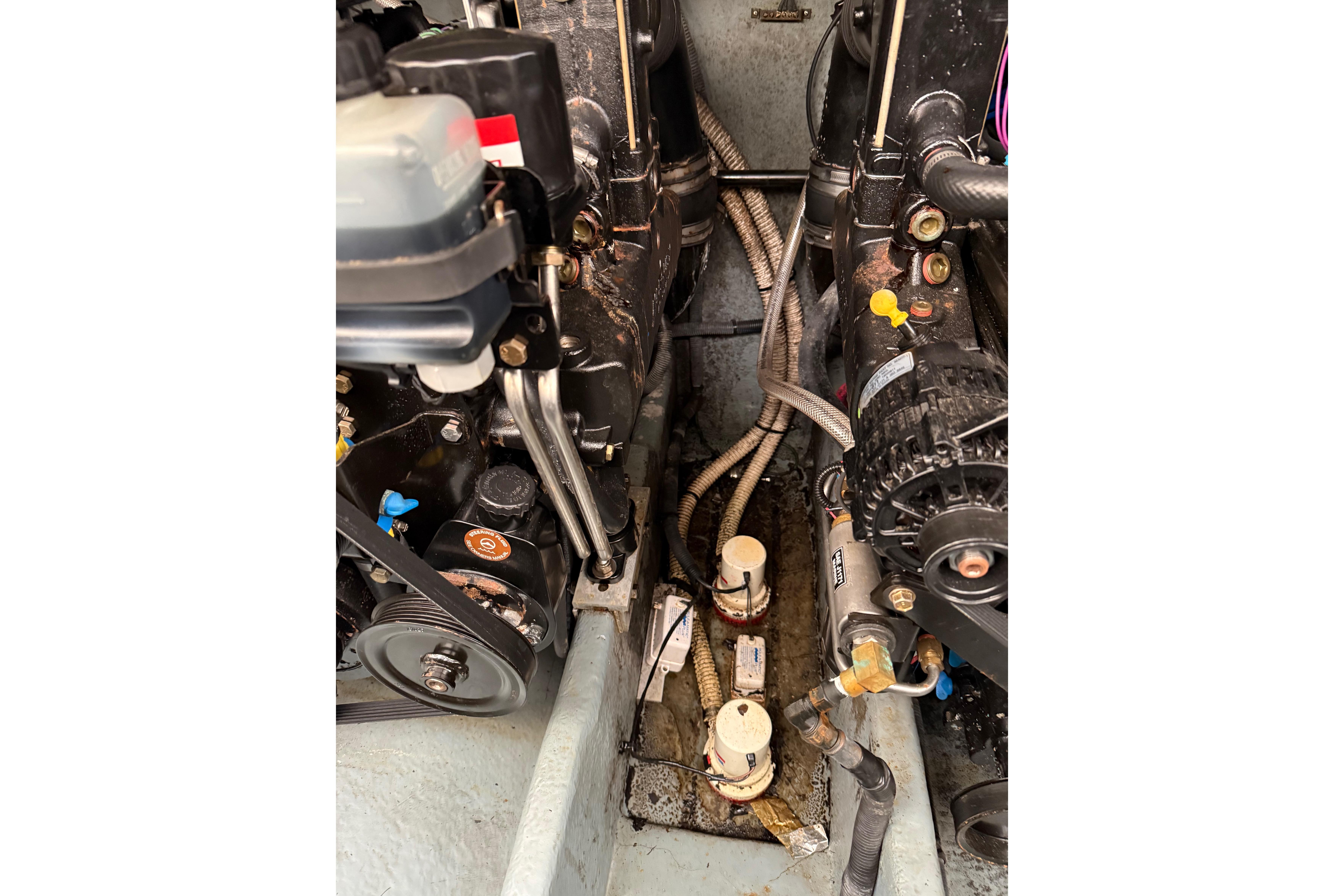 Engine compartment of a 2001 Sea Ray Sundancer 310 boat, showing mechanical components.