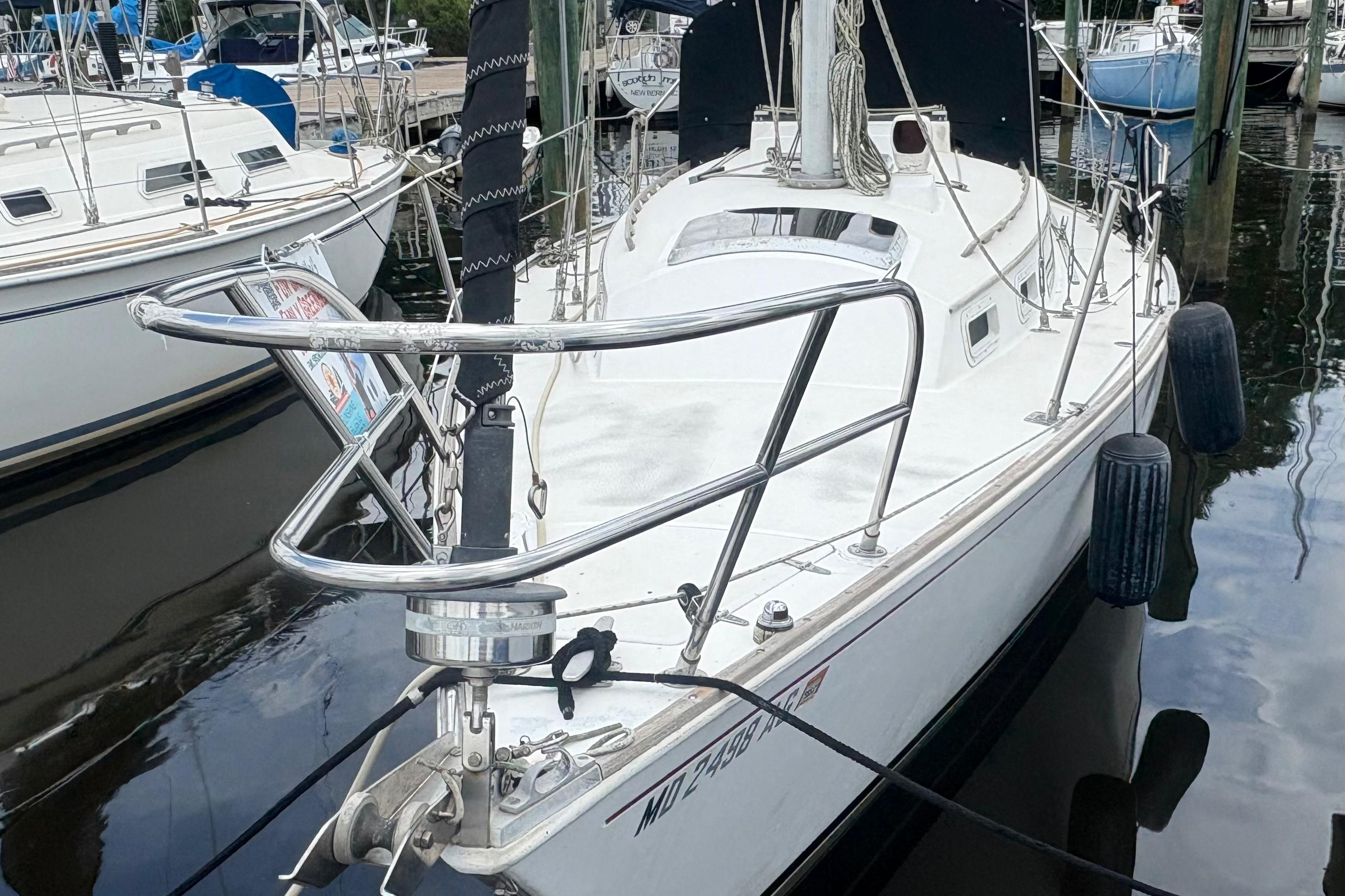 1981 Sabre 31 sailboat docked at marina, featuring sleek design and stainless steel railings.