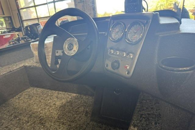 Steering console of 2026 Tracker Pro Guide V-16 SC boat with gauges and controls.