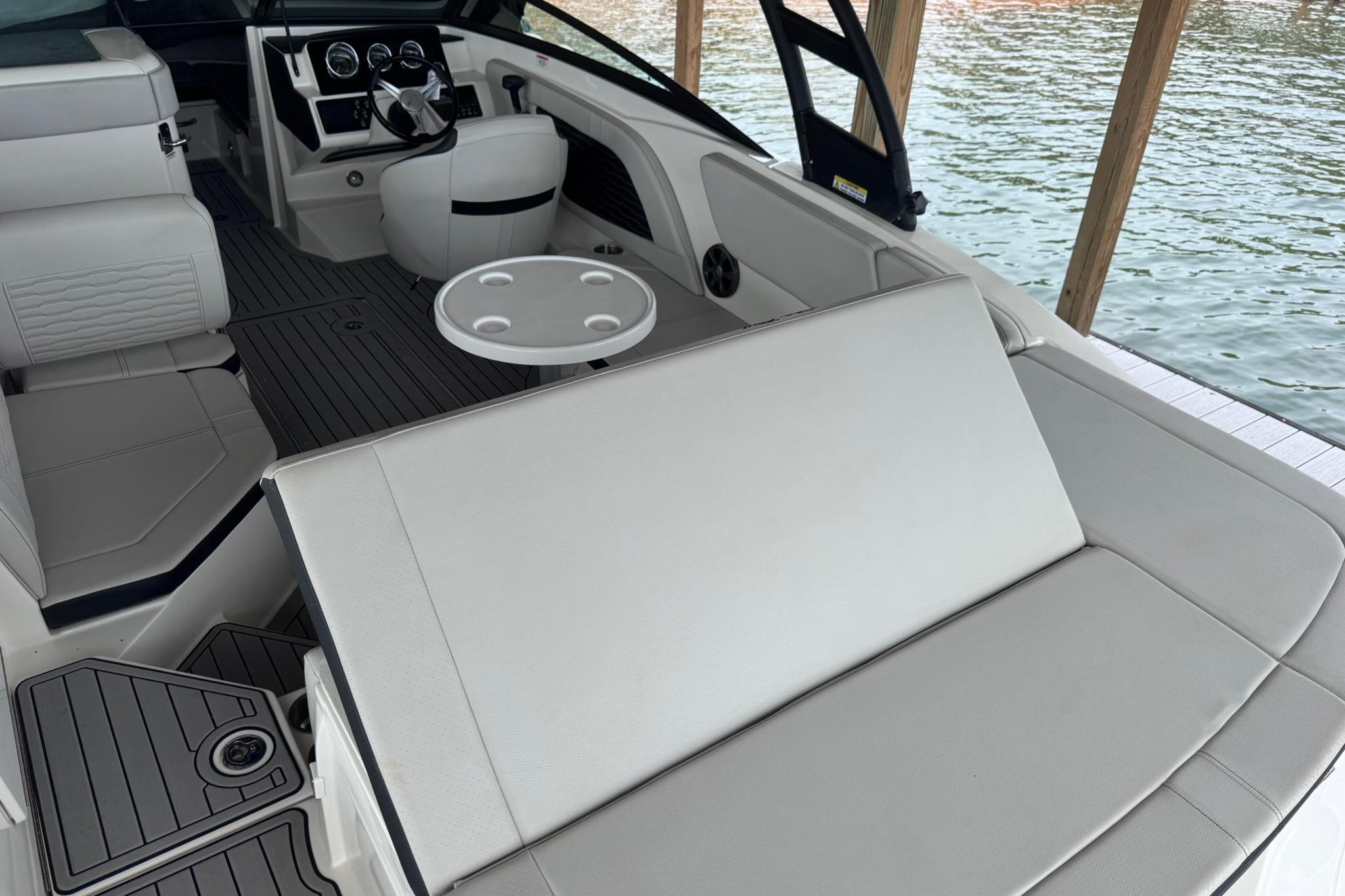 Interior of a 2021 Sea Ray SPX 230 boat with seating and steering wheel.