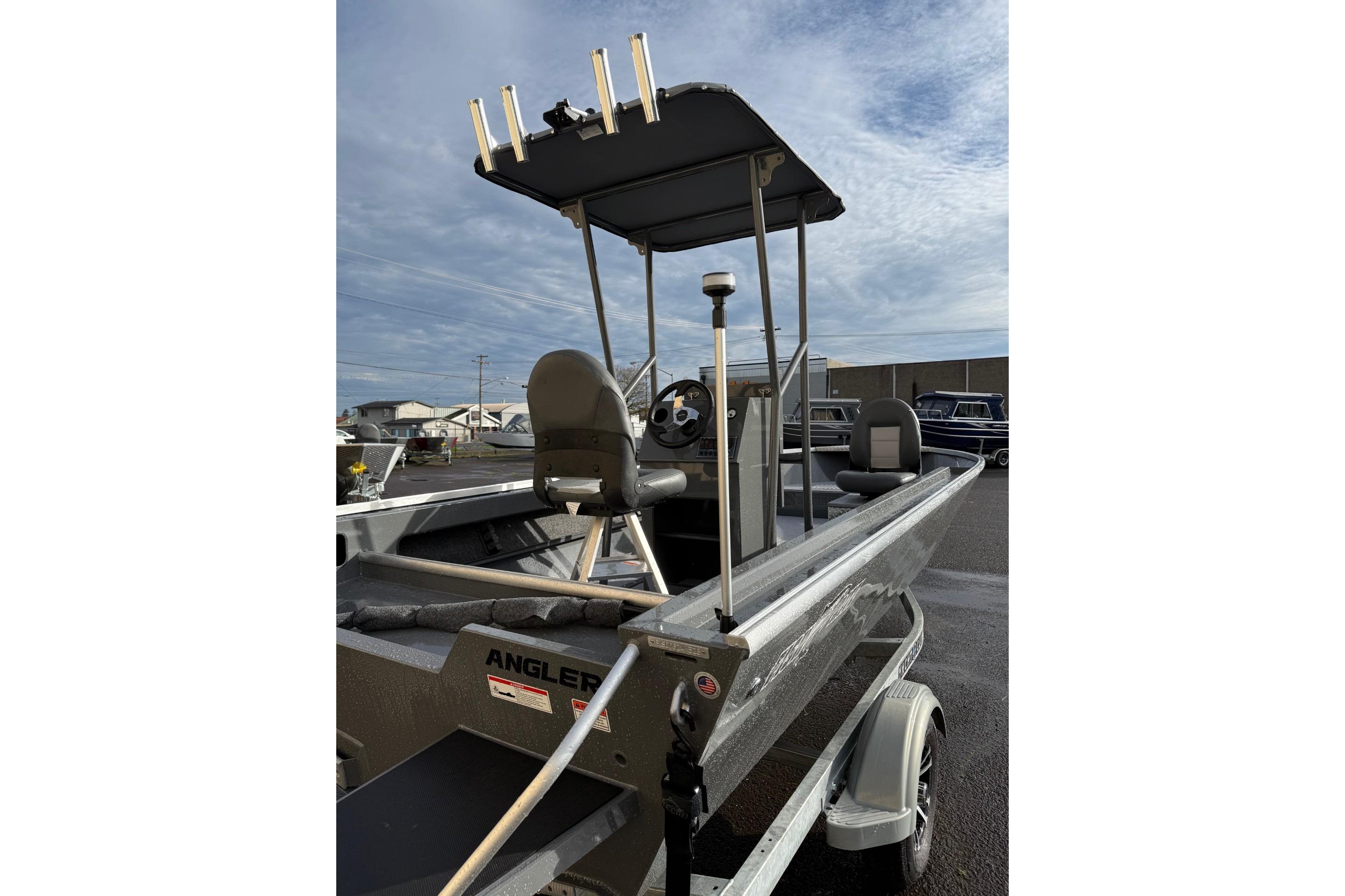 2026 Fish Rite Angler 18 boat with canopy and seating, parked outdoors.