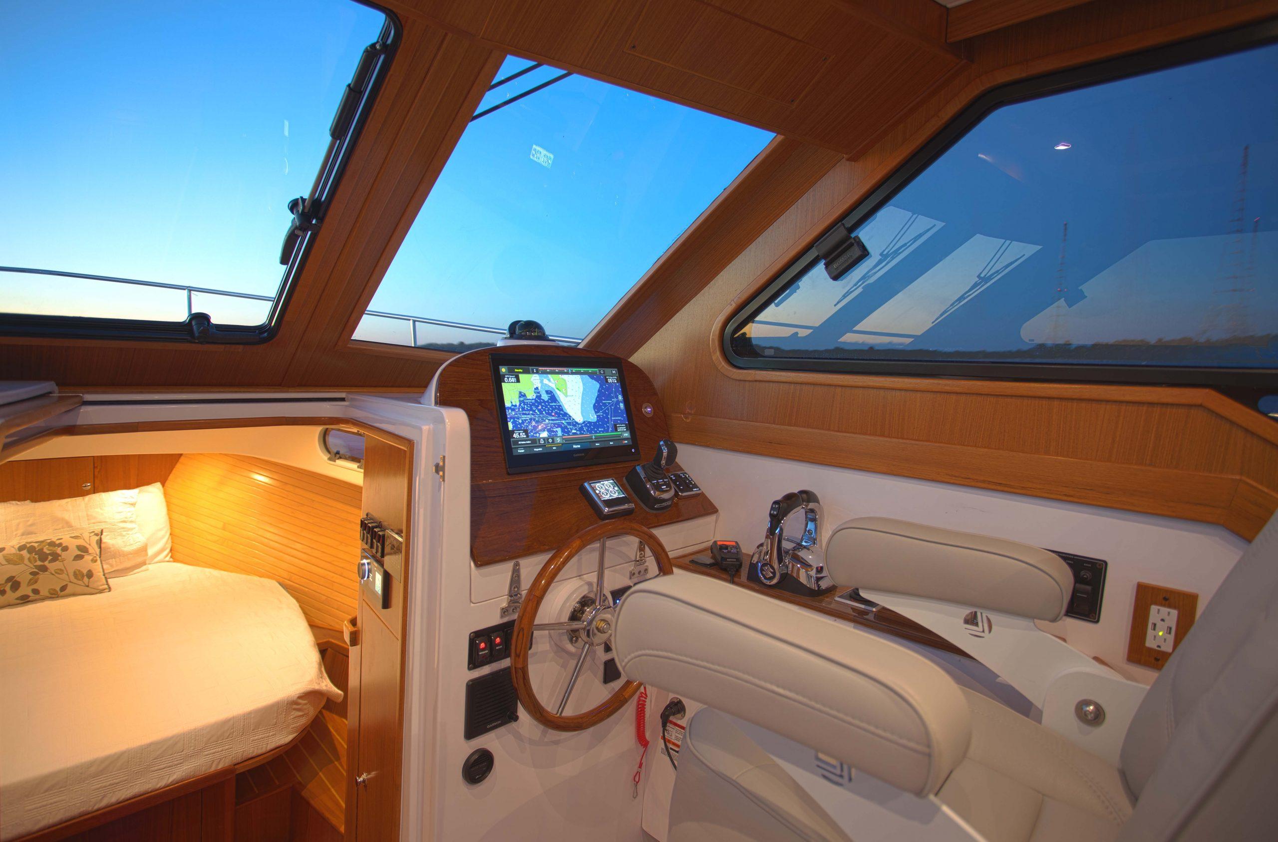 Luxurious 2024 True North 34 yacht interior with navigation system and cozy cabin.