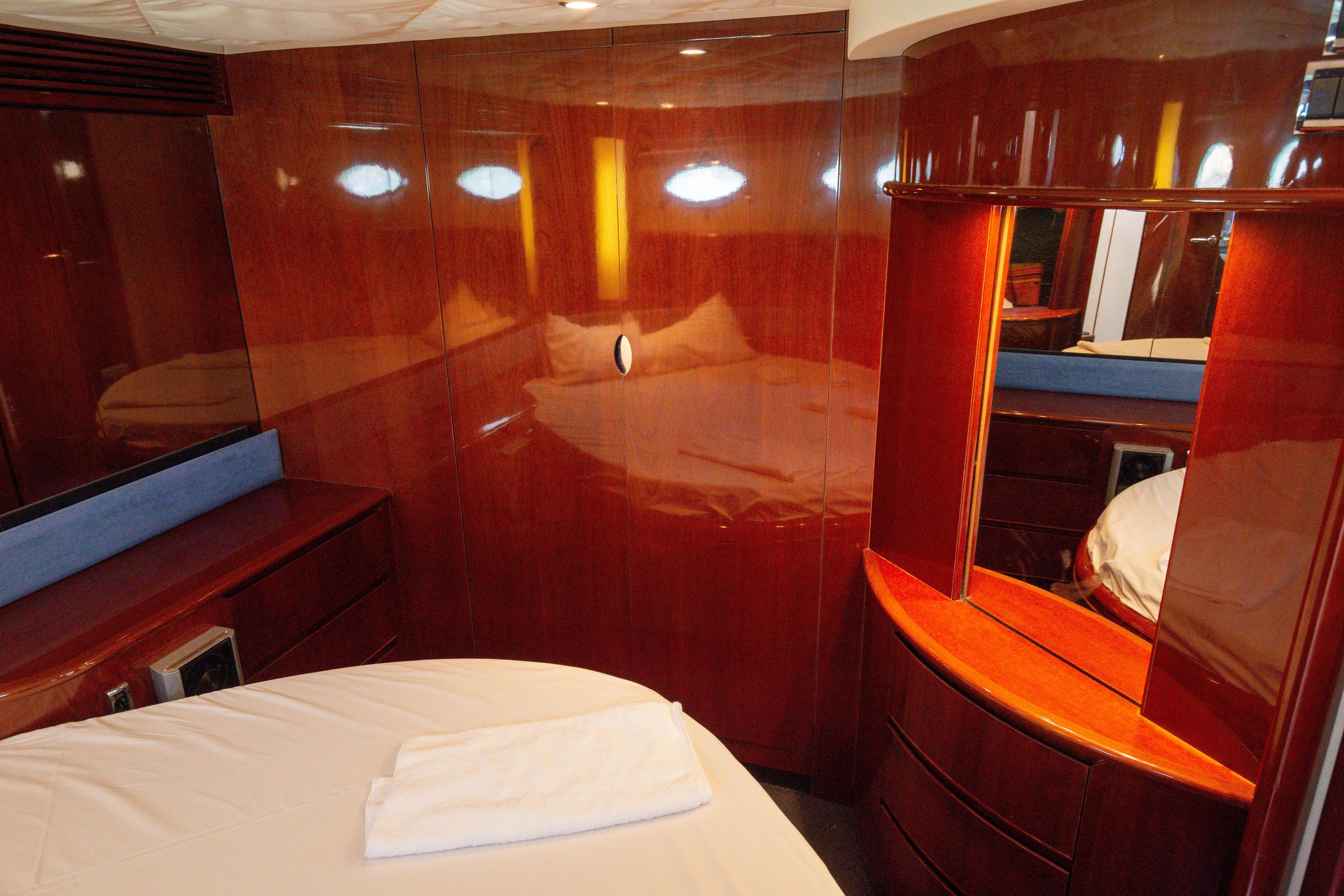 Luxurious cabin interior of 2004 Princess V65 yacht with polished wood finish.