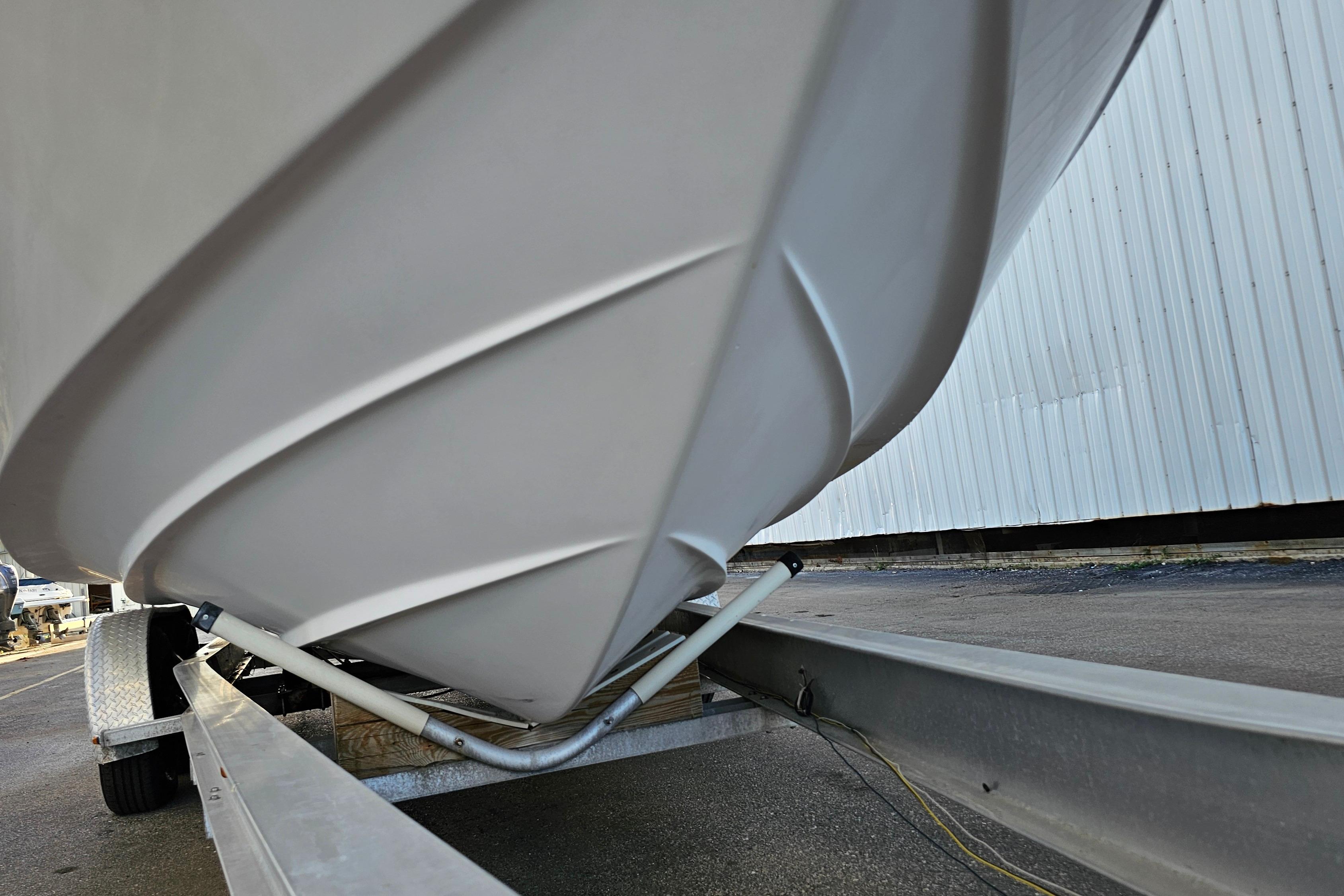 2005 Regal 3060 Window Express boat on trailer, close-up view of hull and trailer.