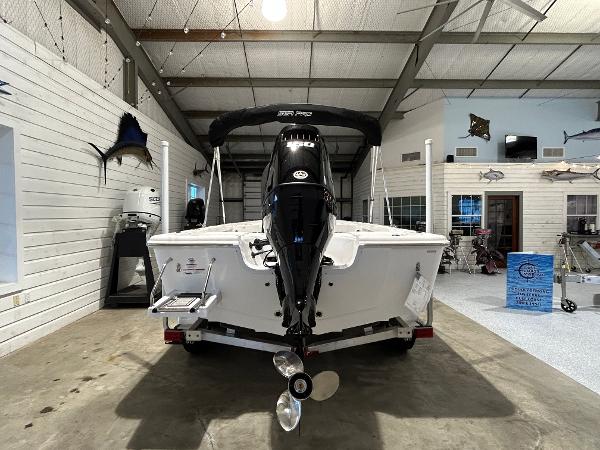 2025 Sea Pro 210 Bay boat in showroom, rear view with motor and propeller.