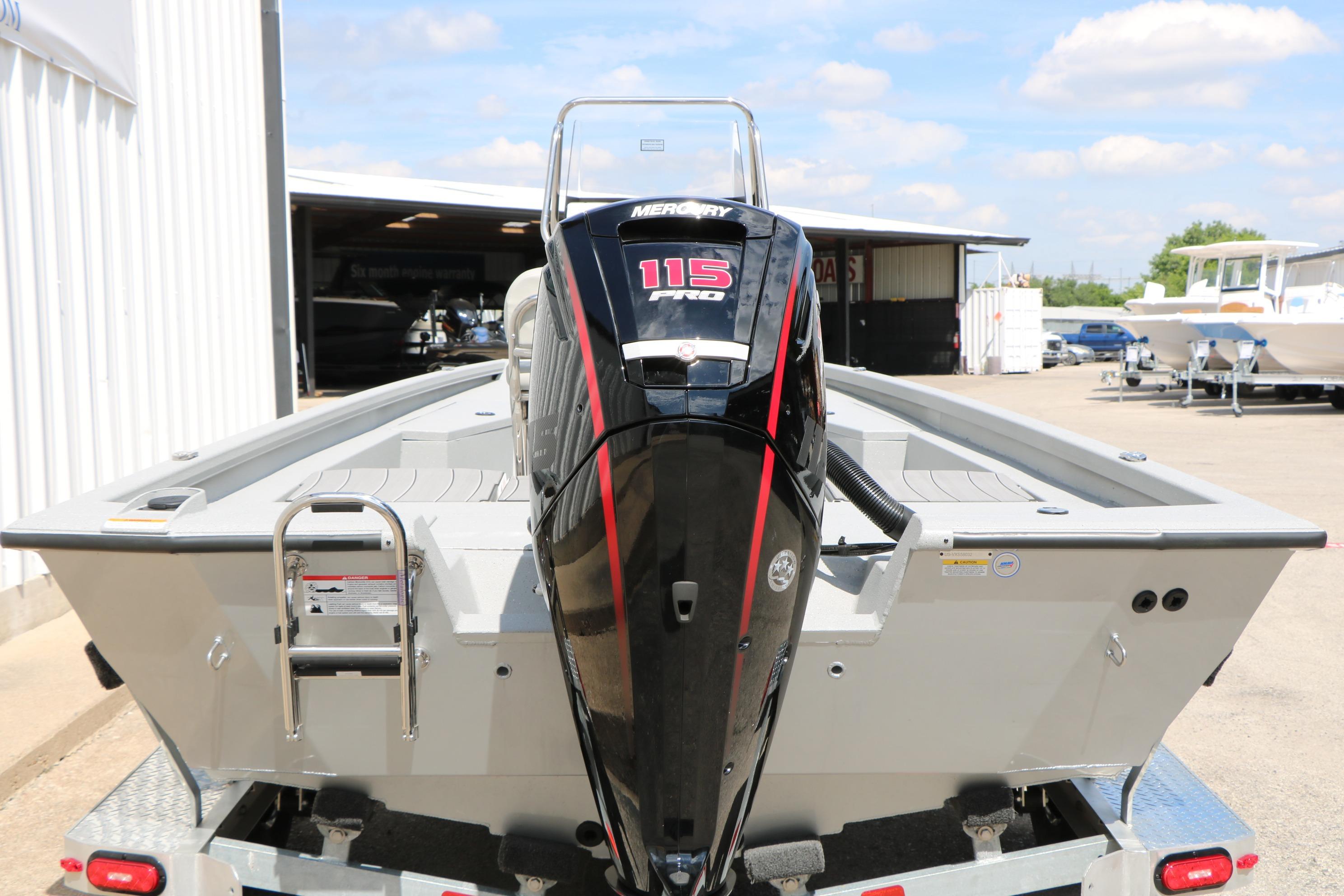 2026 Vexus Defender 201 boat with Mercury 115 Pro outboard motor, parked outdoors.