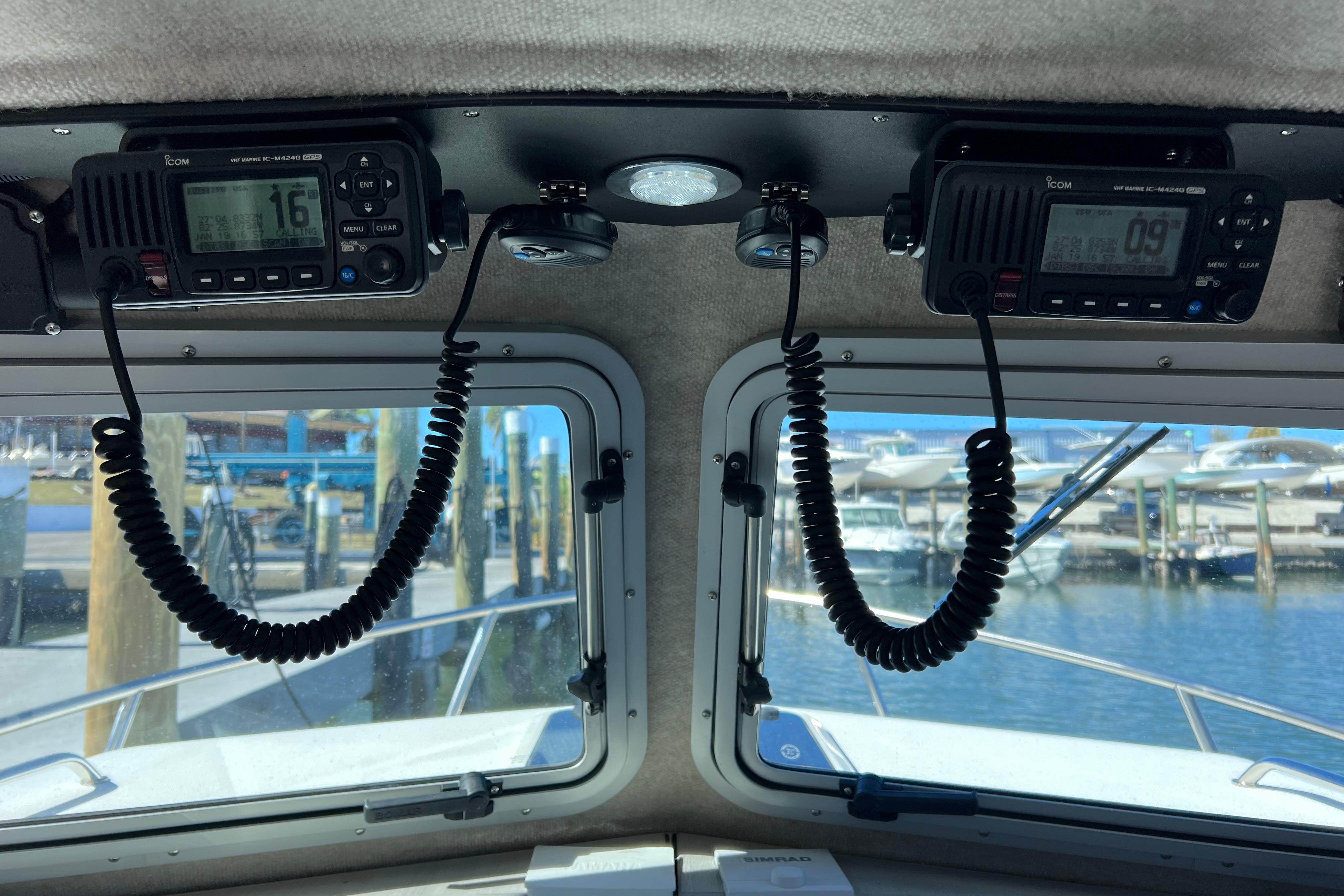 Interior view of 2023 Parker 2820 XLD Sport Cabin with marine radios and dockside scenery.