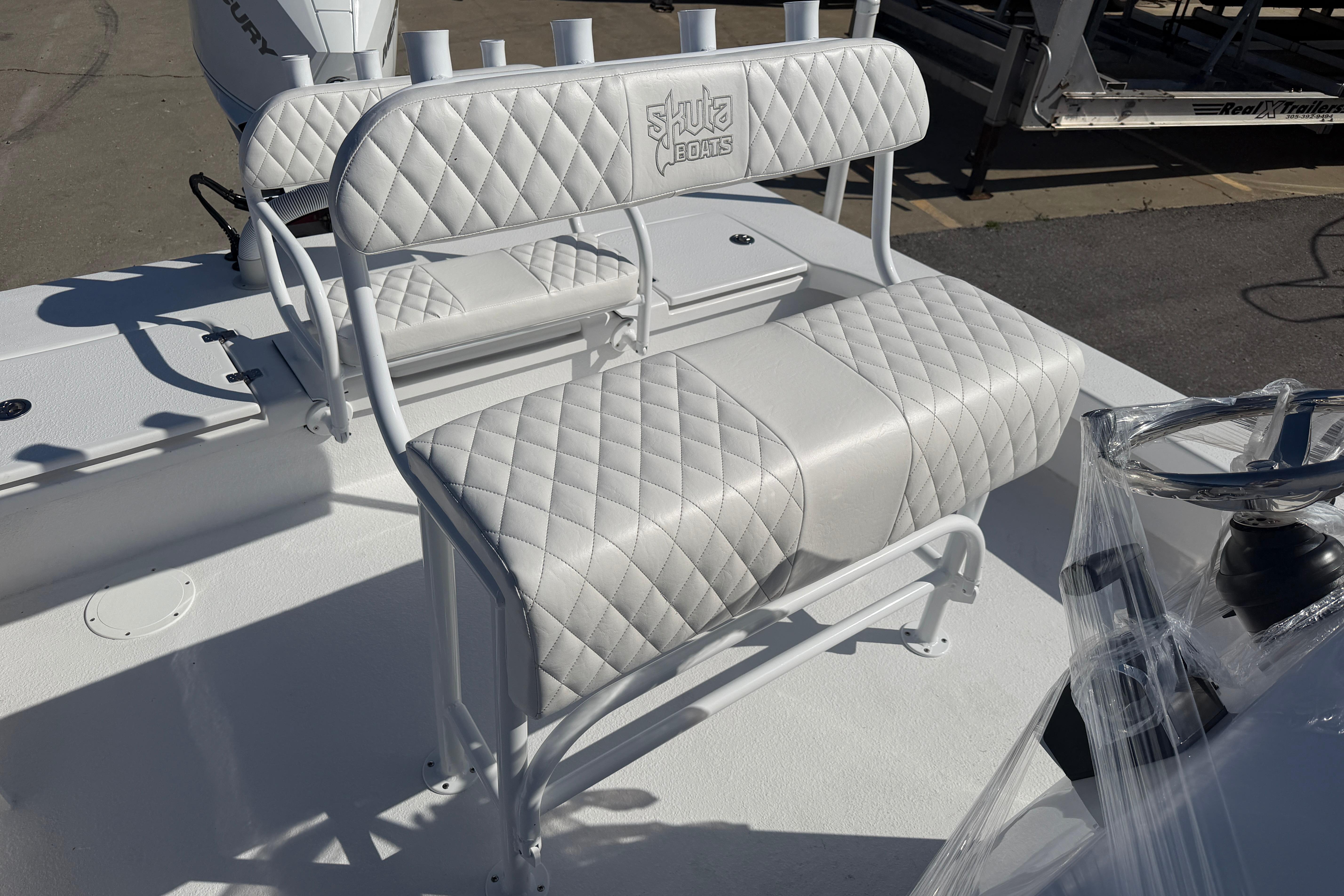 White quilted seating on a 2026 Skuta 24 Cat boat, featuring sleek design and comfort.