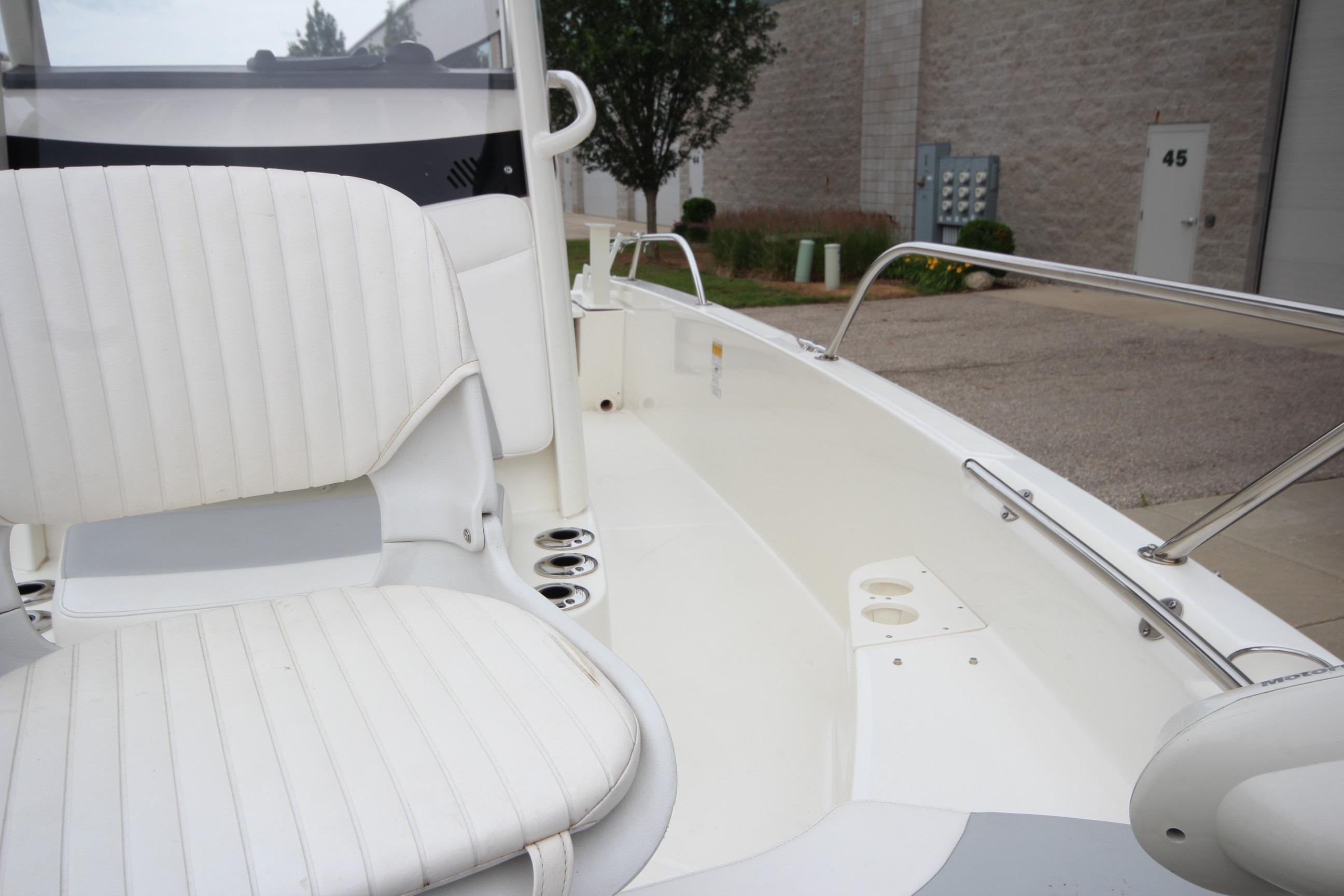 2014 Boston Whaler 210 Dauntless boat interior with white seating and stainless steel railings.