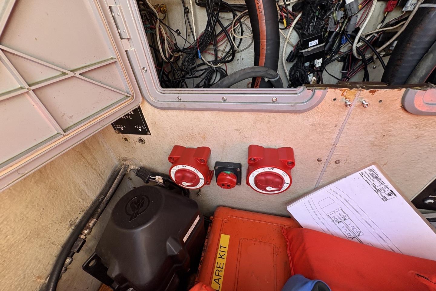 Boat engine compartment with wiring, switches, and safety equipment; Parker 1000 Baltic, 2018 model.