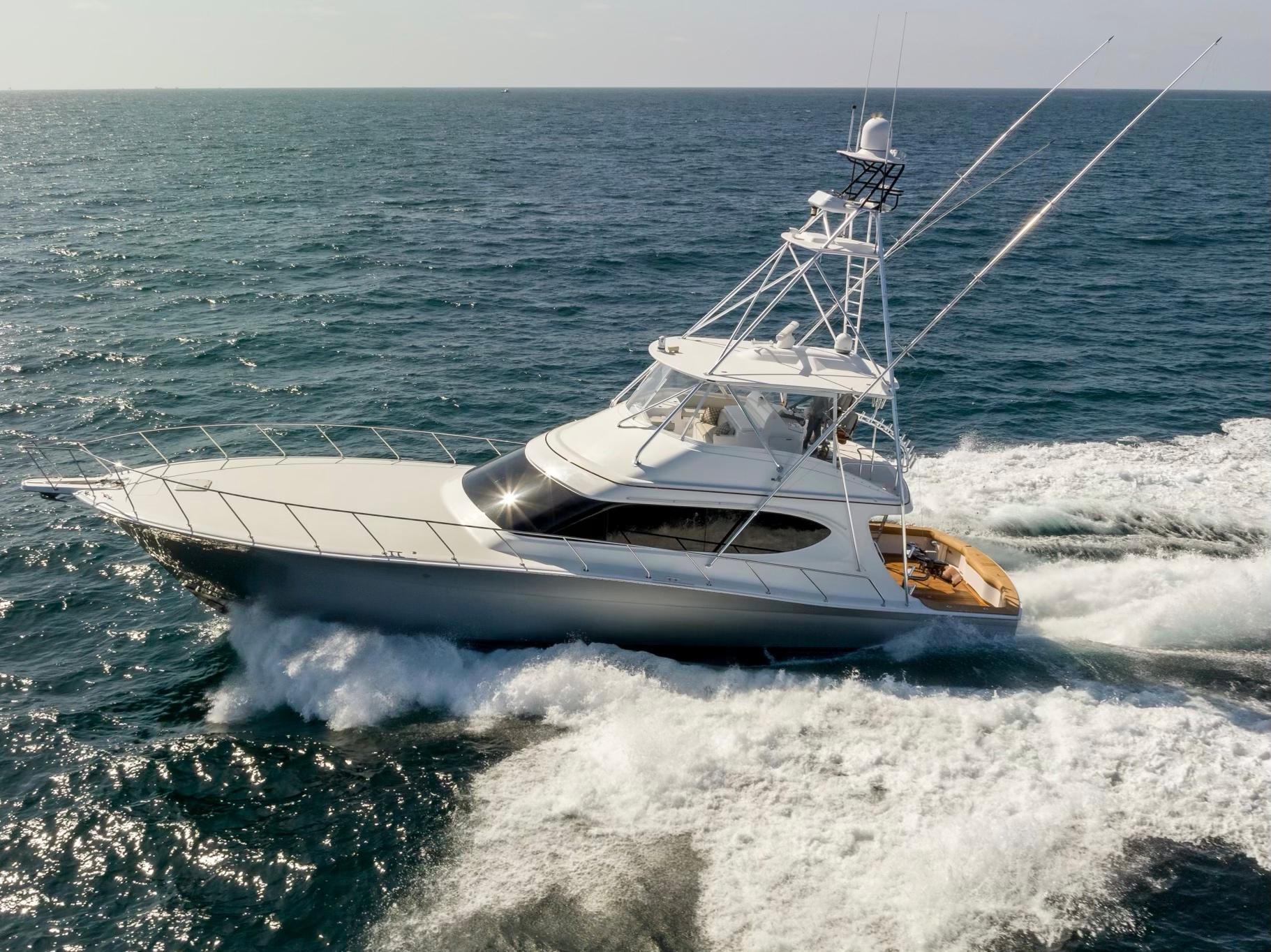 2018 Hatteras GT70 yacht cruising on open sea, showcasing sleek design and powerful performance.