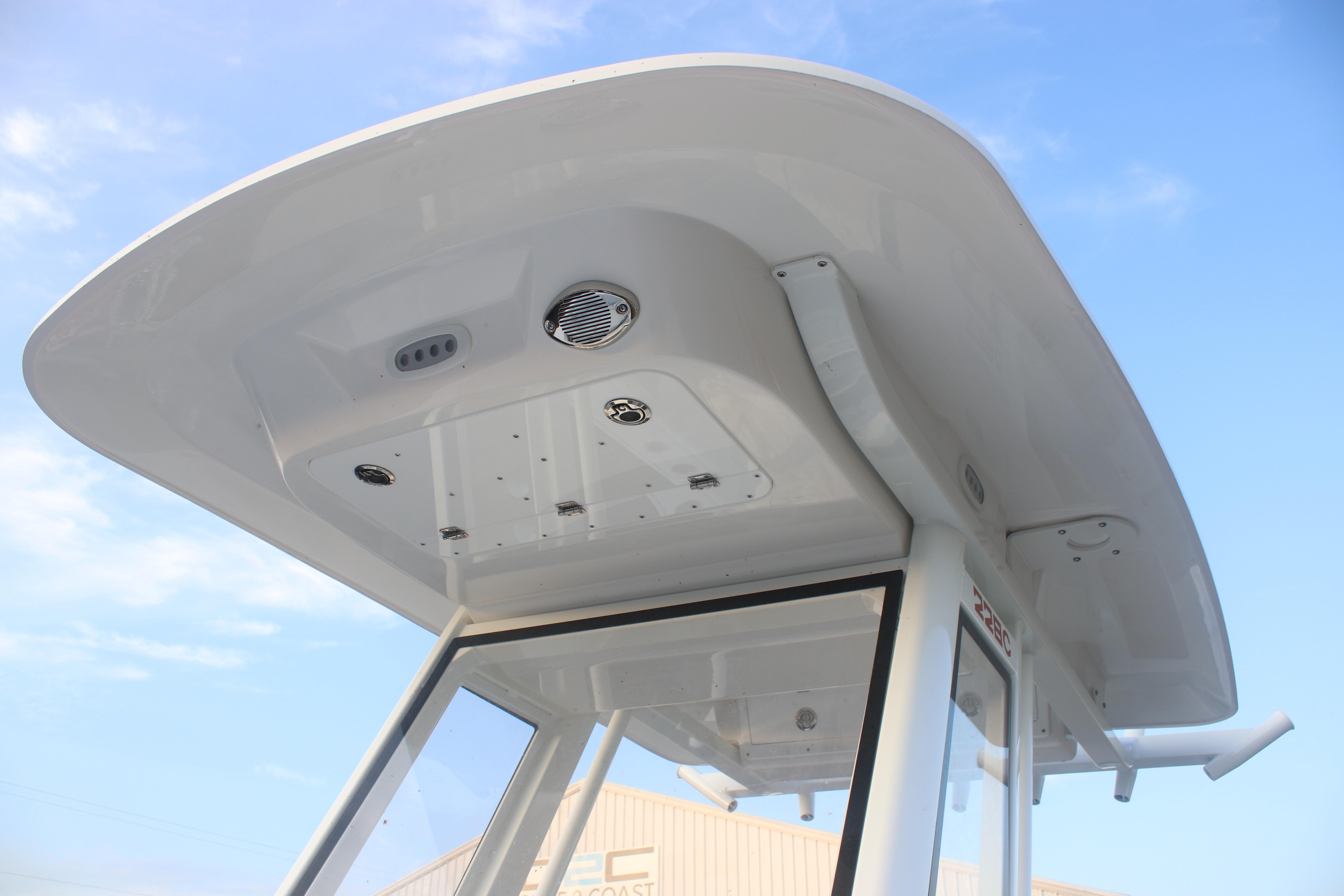 2026 Sea Fox 228 Commander boat's T-top and console against blue sky.