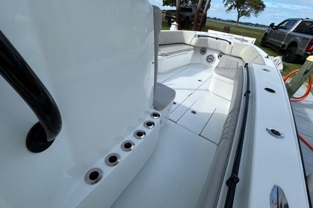 2023 Contender 32 ST boat interior with seating and rod holders, docked outdoors.