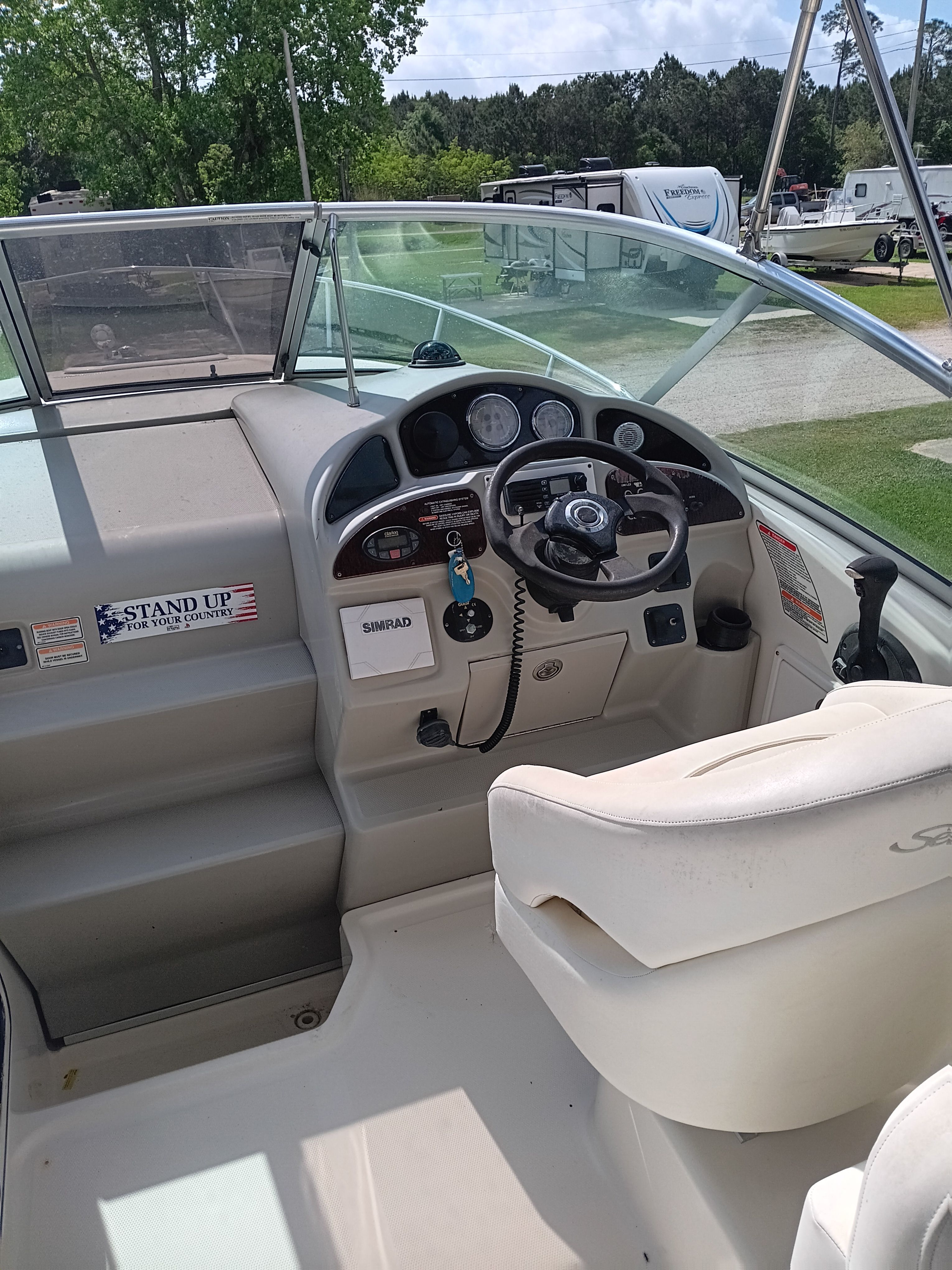 The cockpit of a 2005 Sea Ray 260 DA Sundancer with steering wheel and instruments.