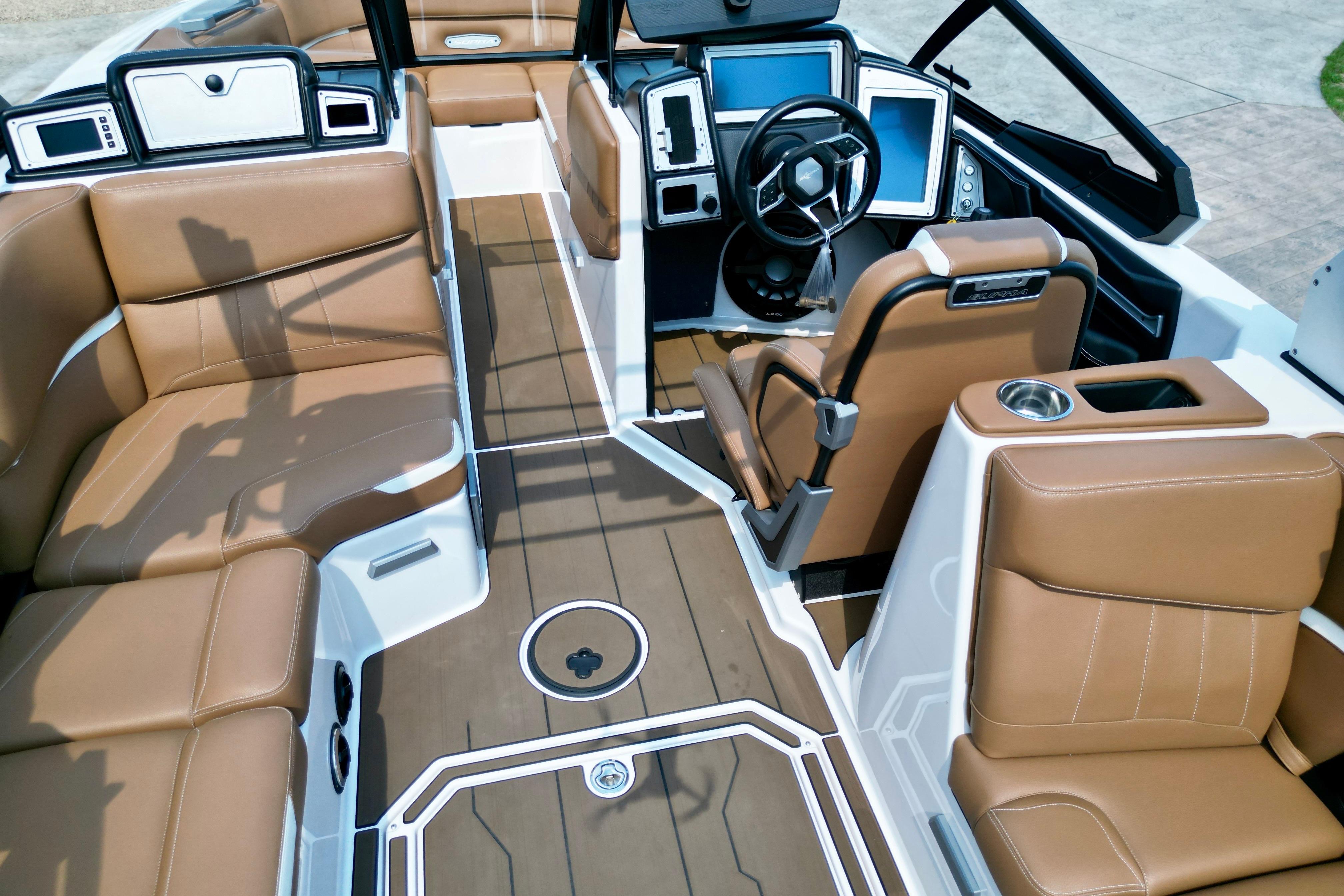 2021 Supra SE boat interior with luxurious brown seating and modern dashboard design.