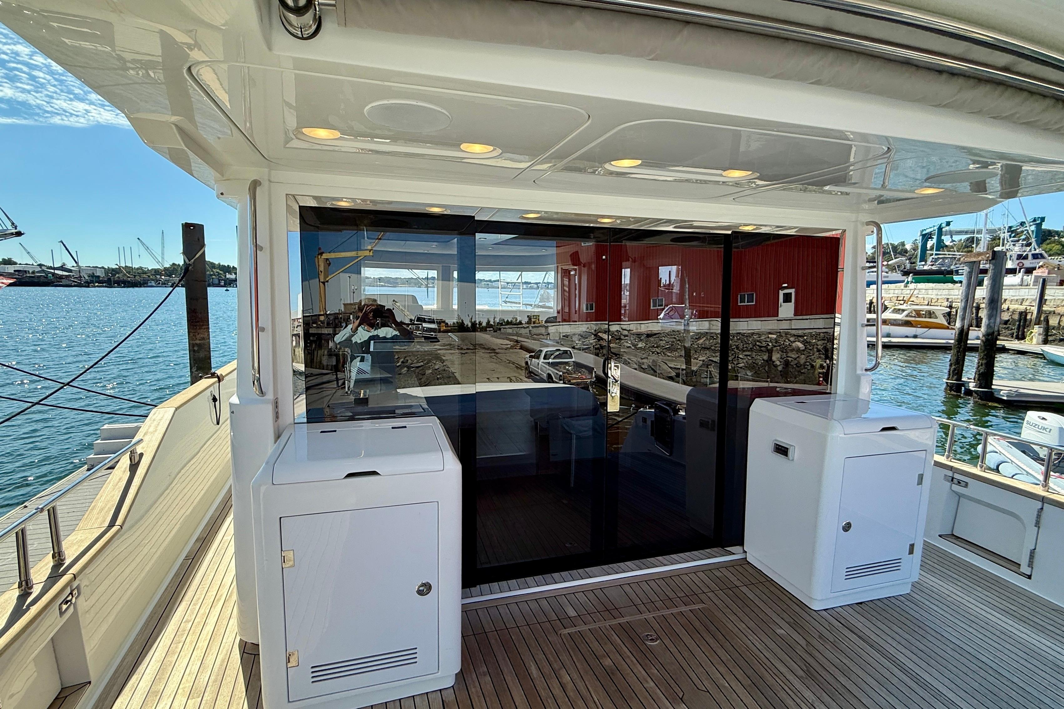 Luxurious 2022 Sirena 58 yacht deck with modern amenities and waterfront view.