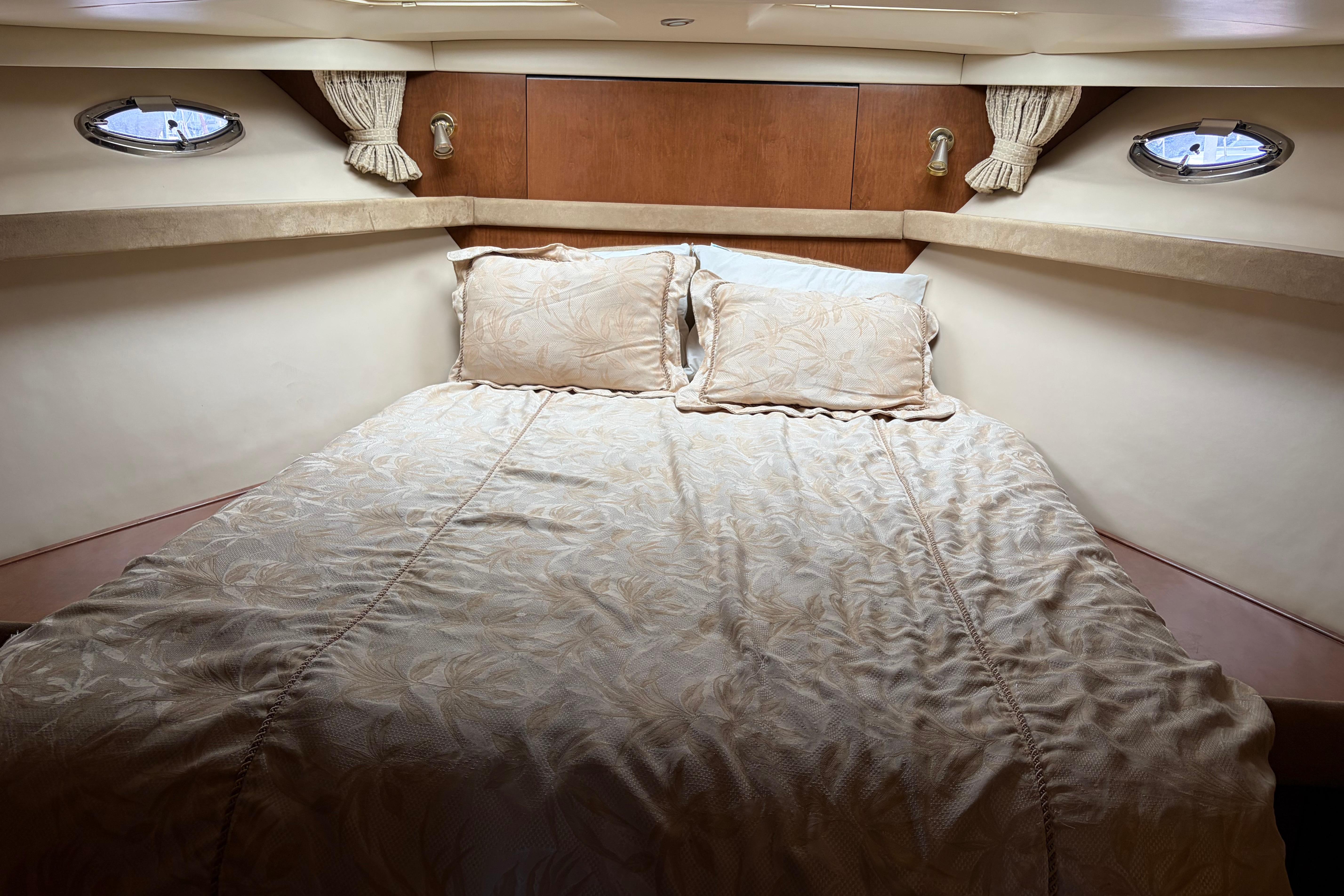 Luxurious cabin interior of 2005 Meridian 490 Pilothouse yacht with elegant bedding.