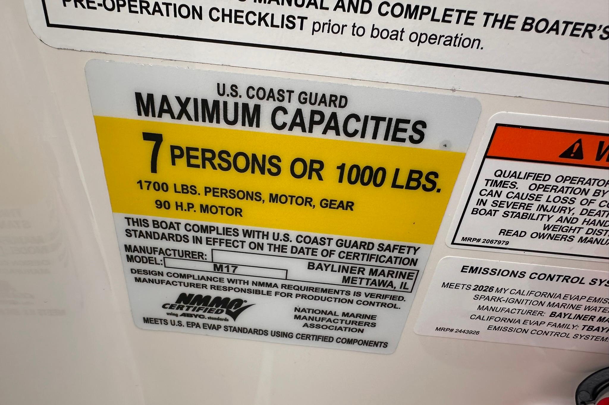 Bayliner M17 2026 capacity label: 7 persons or 1000 lbs, 90 HP motor.
