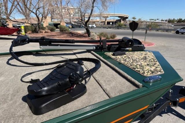 2026 Tracker Bass Tracker Classic Limited boat with trolling motor in a parking lot.