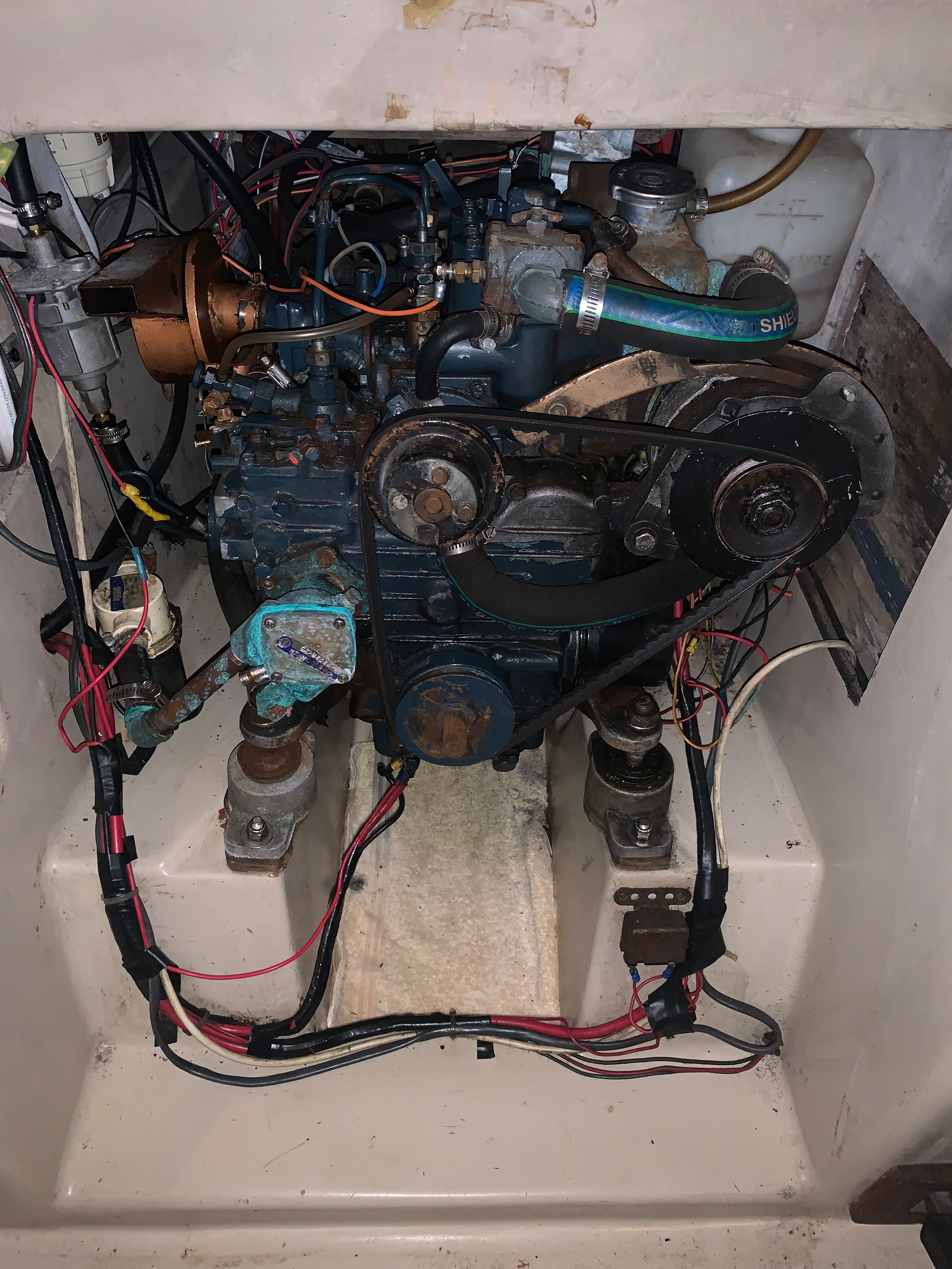 Engine compartment of a 1980 Newport 30 sailboat with visible wiring and components.