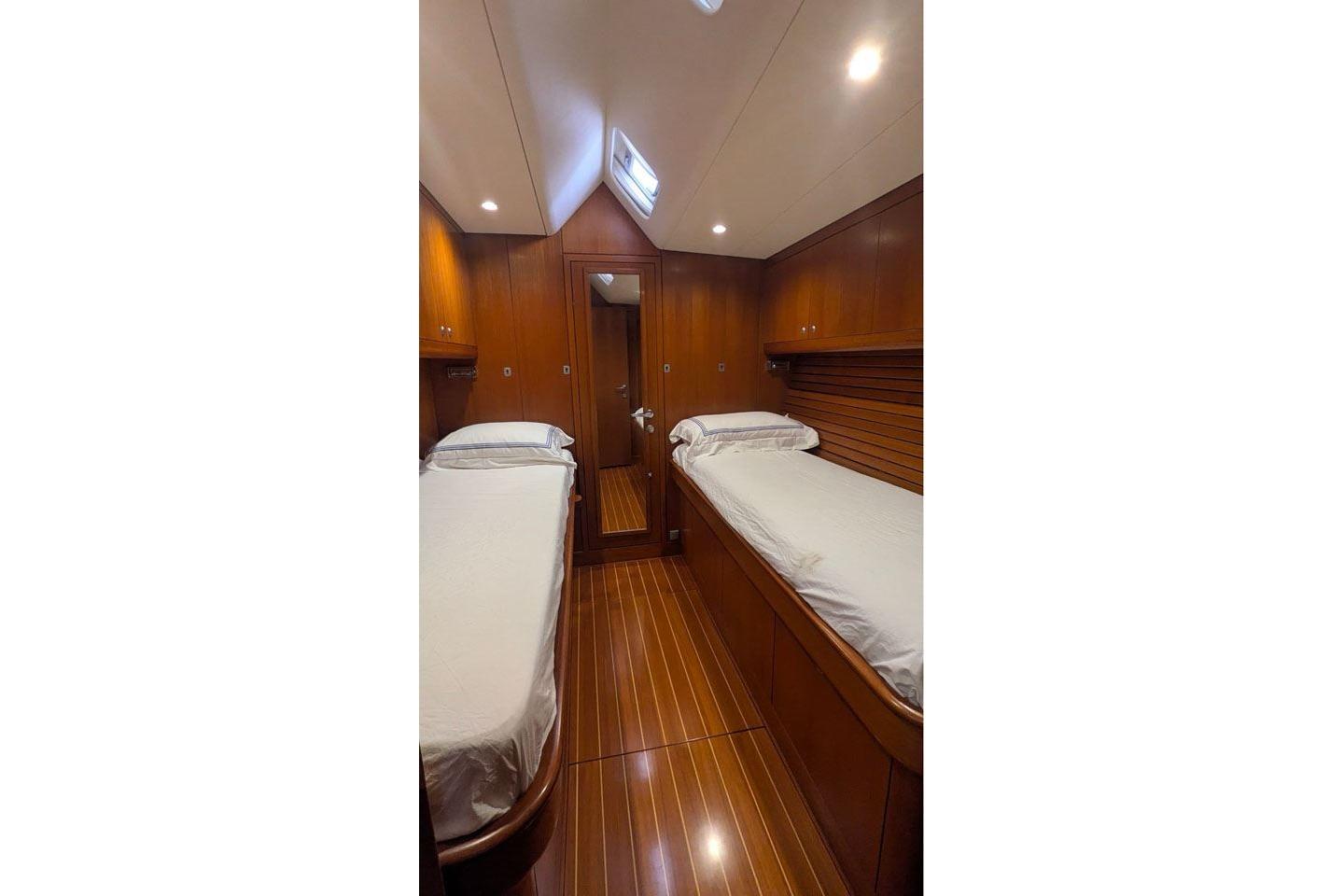 Luxurious wooden cabin interior of 2007 Nautor Swan 75 yacht with twin beds.