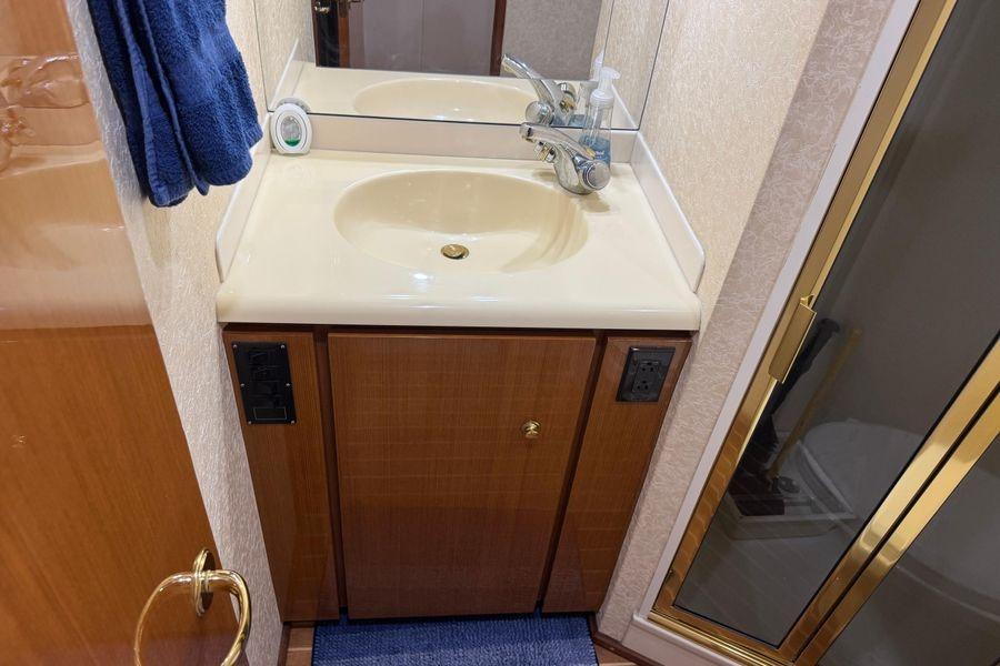 Bathroom vanity and shower in 2002 Viking 61 Enclosed Bridge yacht.