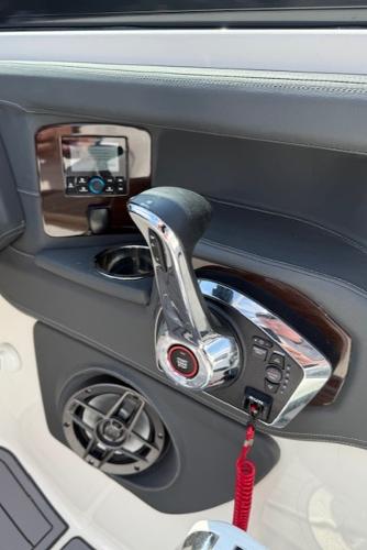 Control panel of 2023 Chaparral 267 SSX boat with throttle and speaker.
